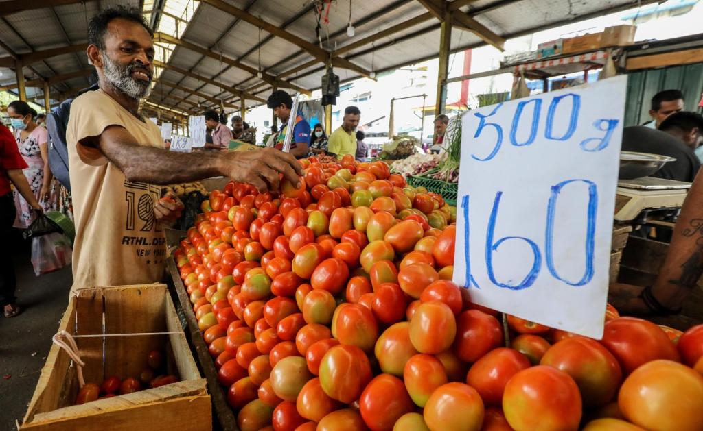 People buy vegetables and fruits for their daily living at a local market in Colombo, Sri Lanka, 02 June 2023. EFE/EPA/CHAMILA KARUNARATHNE
