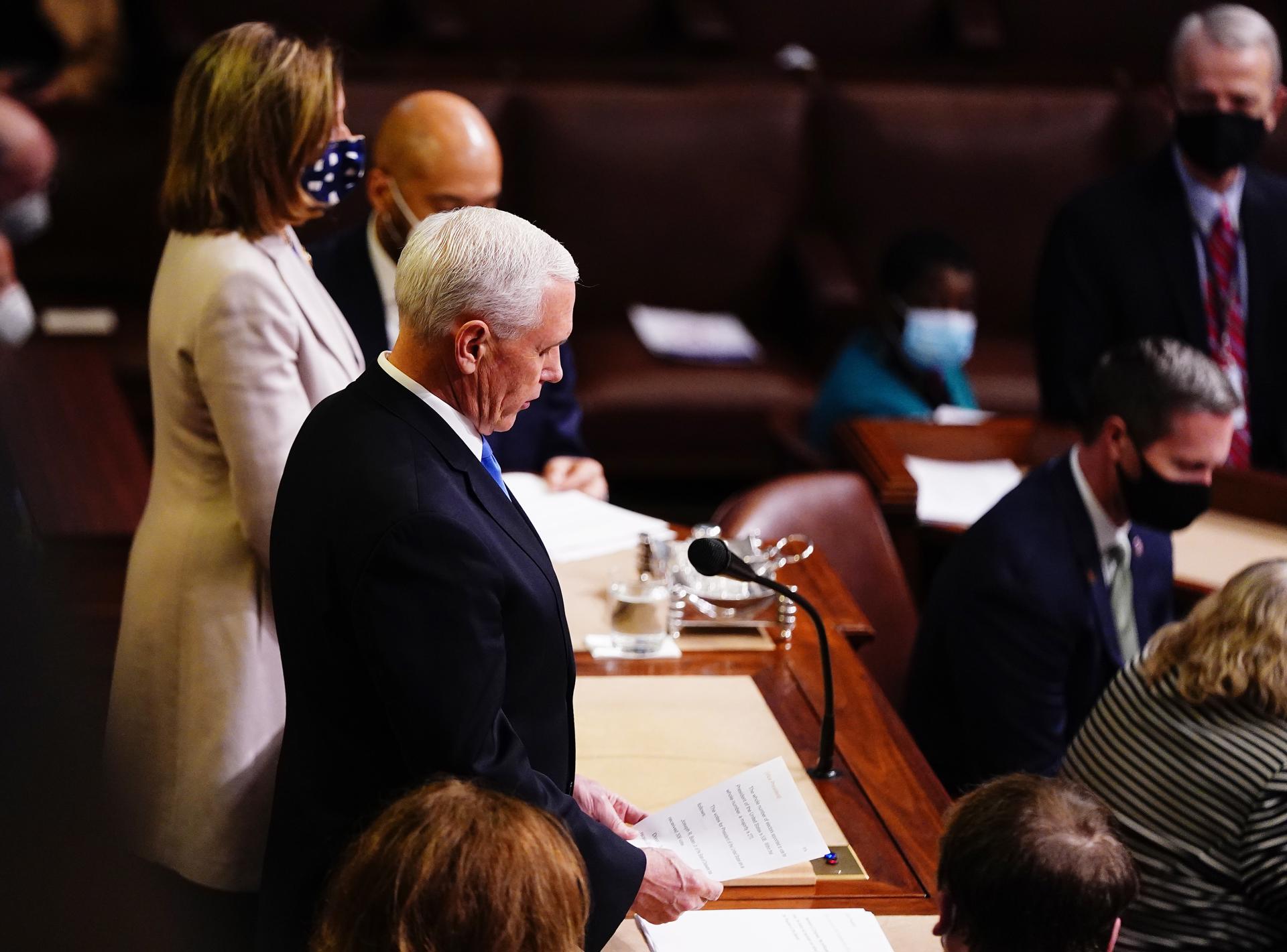 Vice President Mike Pence reads the certification at the end of the joint session of Congress to certify Joe Biden as the next US president in the US capitol in for a further debate in Washington, DC, USA, 07 January, 2021. EFE-EPA FILE/JIM LO SCALZO
