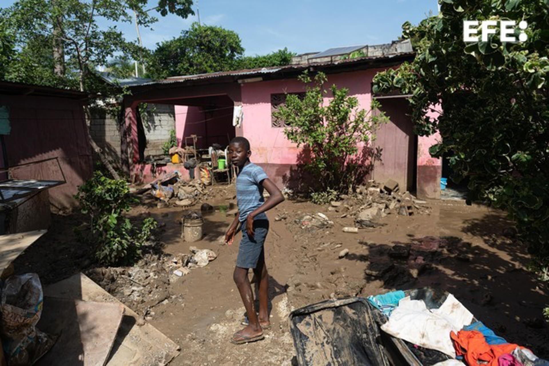 A young man stands in the mud on a street affected by heavy rains, in Leogane, Haiti, 06 June 2023. EFE/ Johnson Sabin