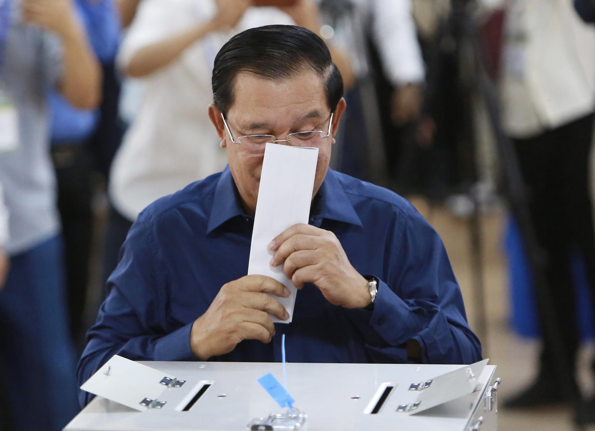 Cambodian Prime Minister Hun Sen kisses his ballot at a polling station in Kandal province, Cambodia, 23 July 2023. EFE/EPA/KITH SEREY
