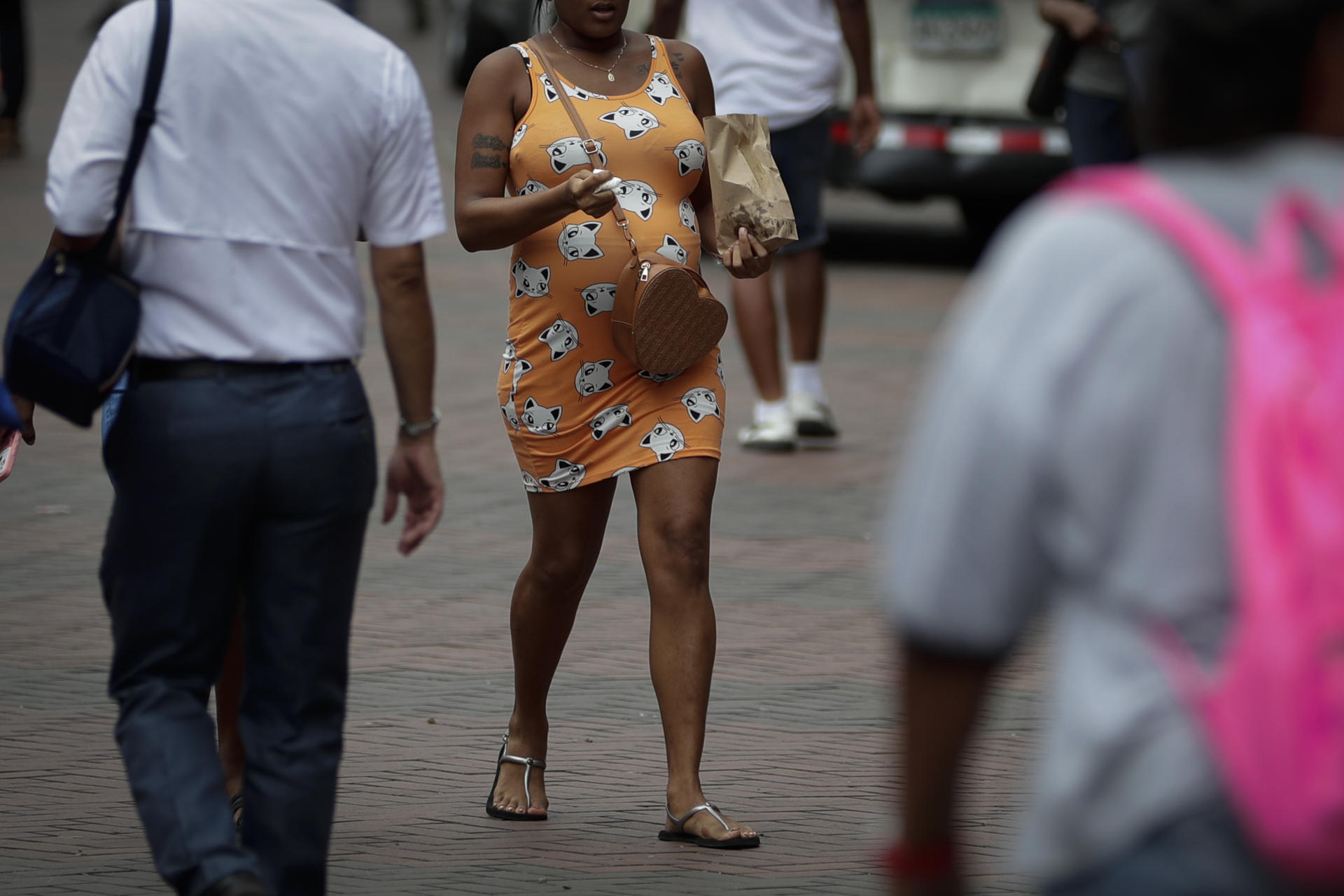 A pregnant woman walks on 27 July 2023 on a downtown street in Panama City, Panama. EFE/Bienvenido Velasco
