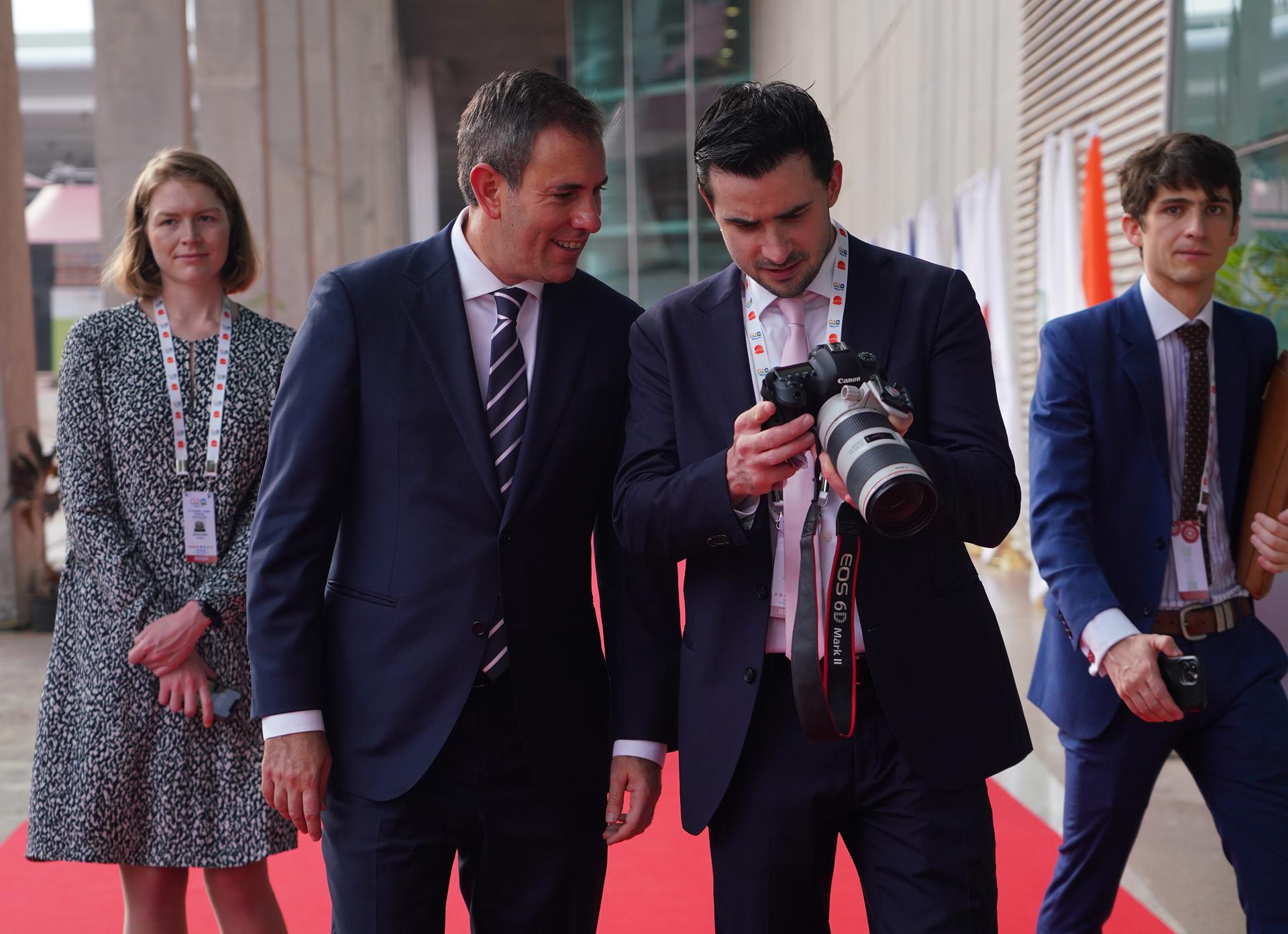 Australia's Finance Minister Jim Chalmers (2-L) looks at his photograph while going to attend the G20 Finance Ministers and Central Bank Governors Meeting (FMCBG and FCBD) in Gandhinagar, India, 18 July 2023. EFE/EPA/SIDDHARAJ SOLANKI
