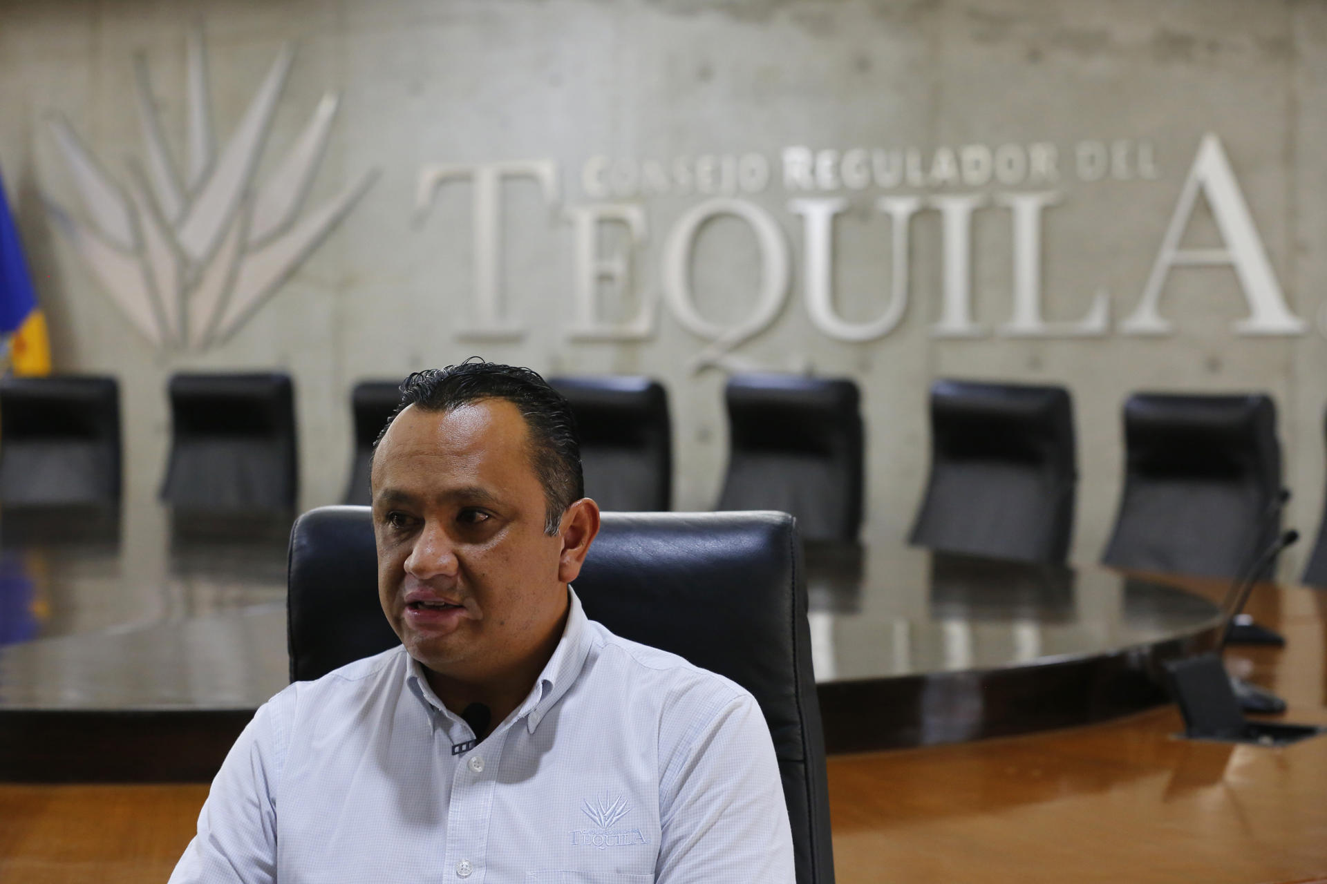 This photograph dated July 14, 2023 shows the director of sustainability projects of the Tequila Regulatory Council (CRT), Carlos López, showing a series of ARA certificate labels in the city of Guadalajara, Jalisco (Mexico). EFE/ Francisco Guasco