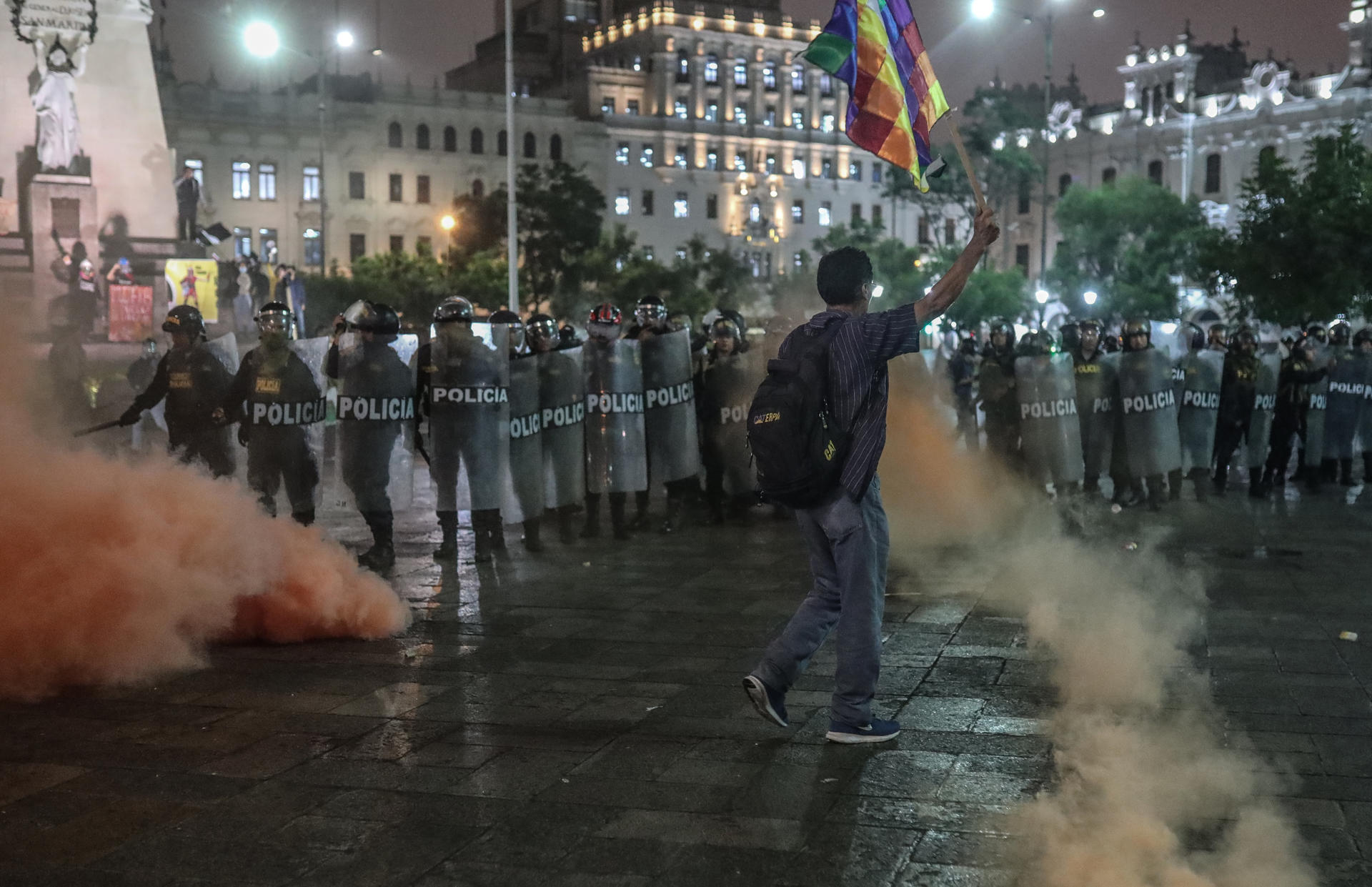 A man waves a flag in San Martín square surrounded by members of the Police during a day of protests in Lima, Peru, 22 July 2023. EFE-EPA/Aldair Mejia
