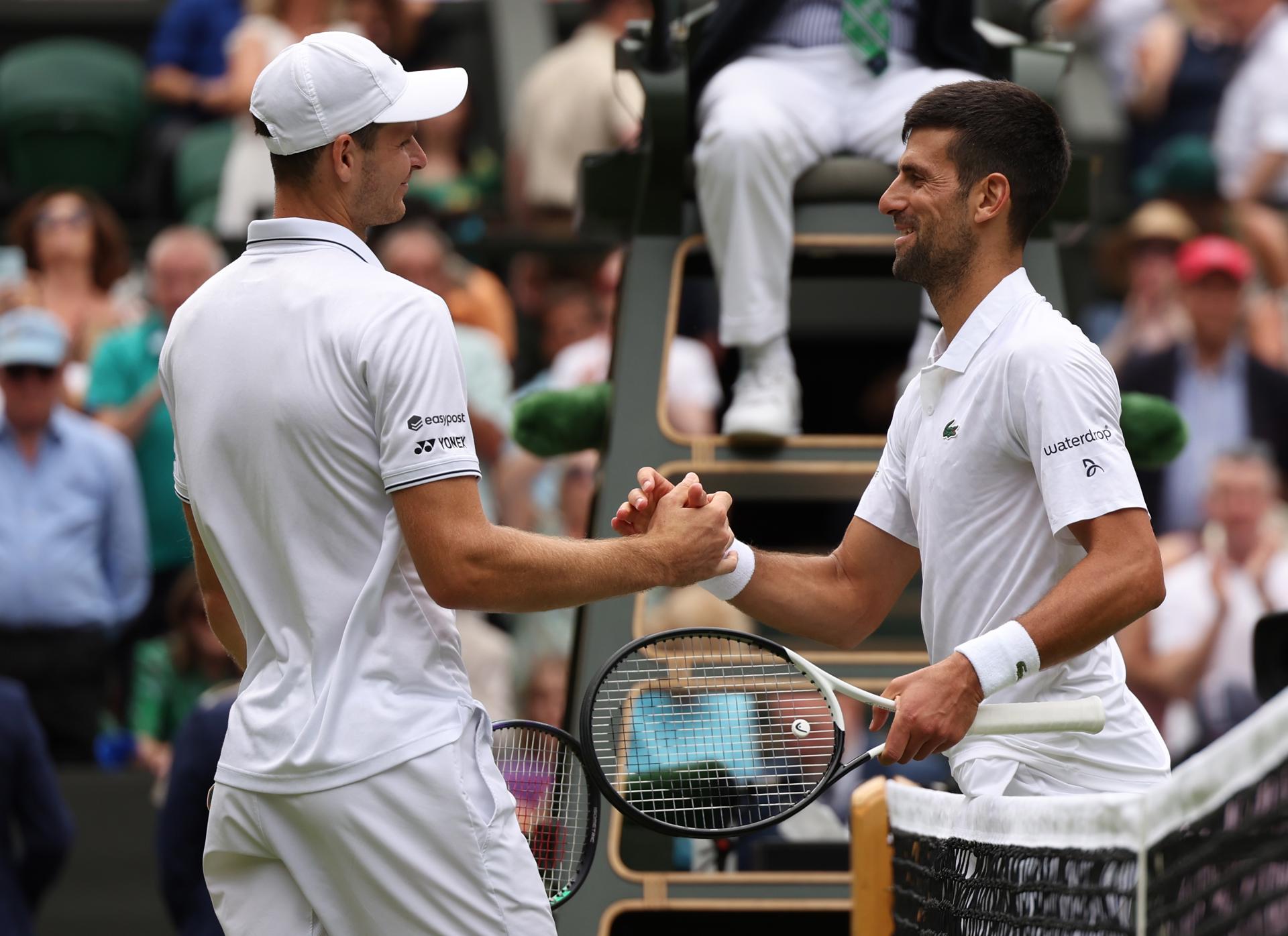 Novak Djokovic (R) of Serbia shakes hands with Hubert Hurcacz of Poland after winning their fourth-round match at Wimbledon on 10 July 2023 in London, United Kingdom. Djokovic won 7-6 (8-6), 7-6 (8-6), 5-7, 6-4. EFE/EPA/NEIL HALL EDITORIAL USE ONLY