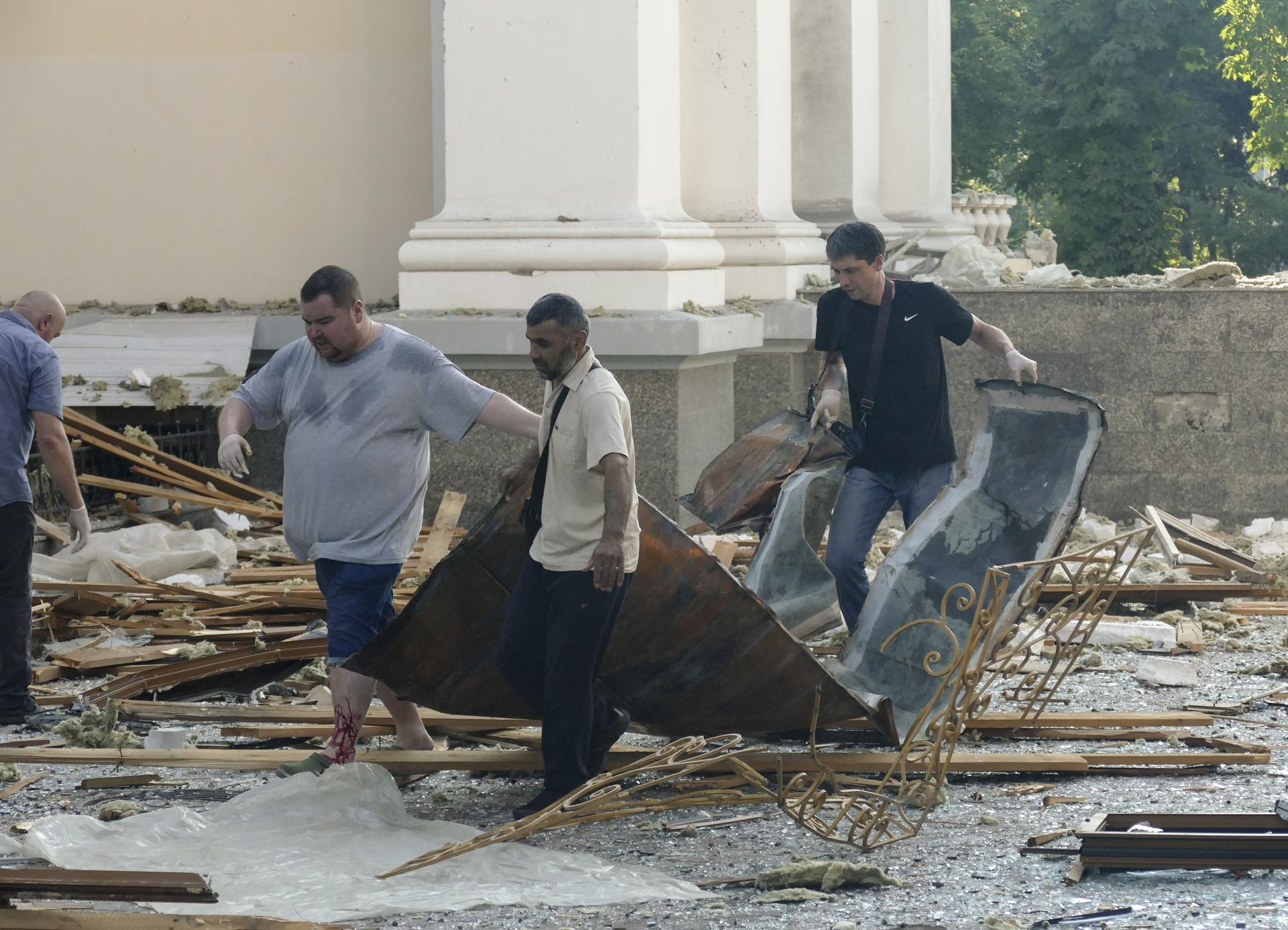 People clean debris near the Transfiguration Cathedral, damaged by a missile attack in the Odesa region, southern Ukraine, 23 July 2023. EFE-EPA/IGOR TKACHENKO
