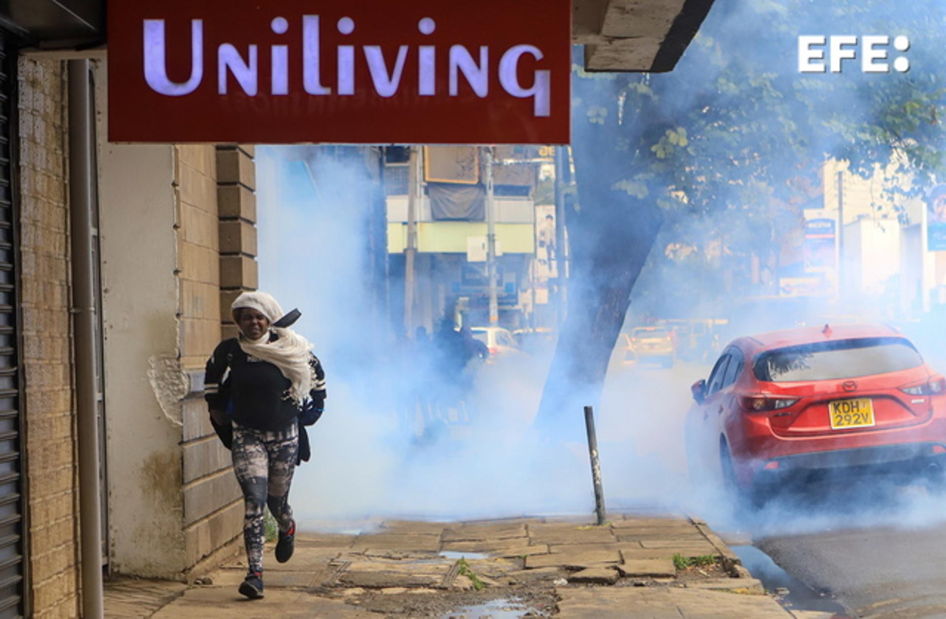A woman runs away from tear gas during a rally against tax increases in Nairobi on 7 July 2023. EFE/EPA/STRINGER
