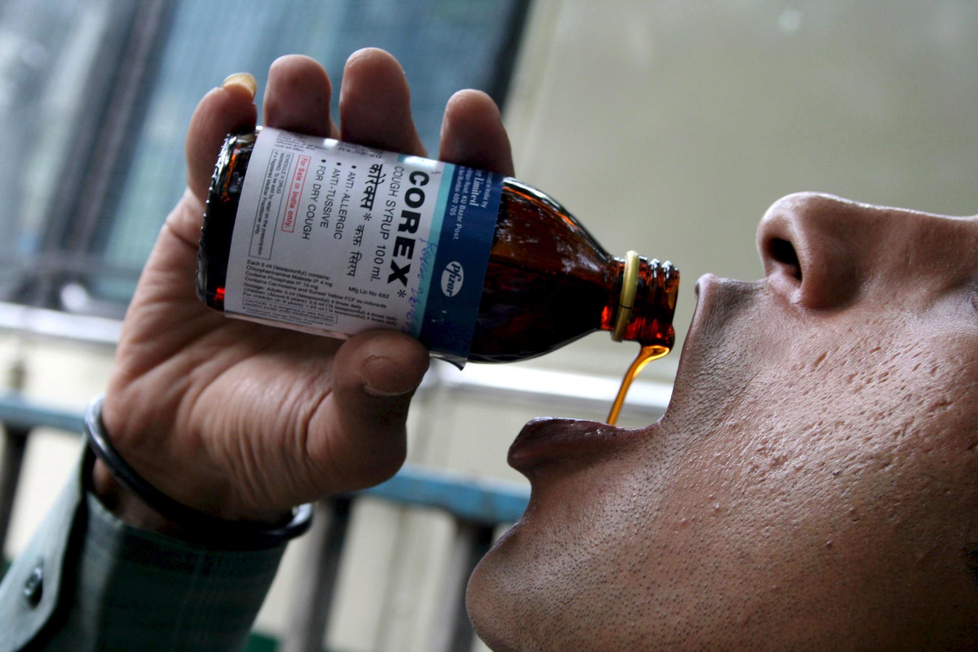 A file picture shows a man consuming a cough syrup in Kolkata, India. EPA/FILE/KAUSHIK SARKHEL
