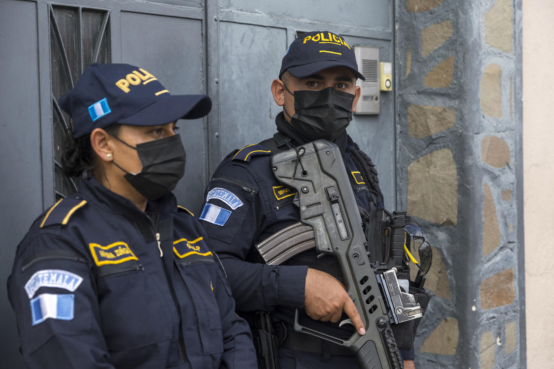 Agents of the Guatemalan Attorney General's Office stand guard during a search of the seat of the Supreme Electoral Court in Guatemala City on 20 July 2023. EFE/Esteban Biba

