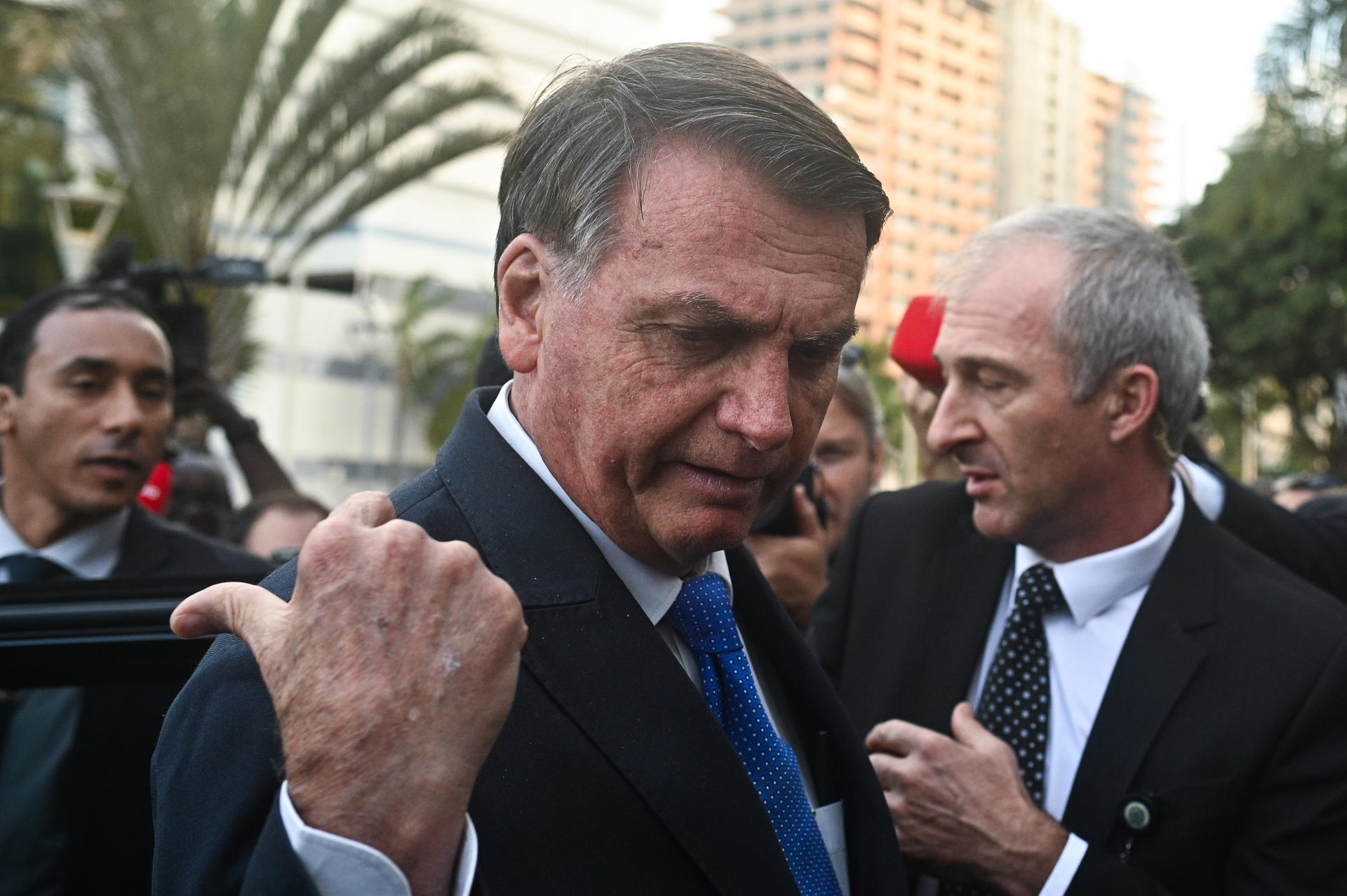 Former President Jair Bolsonaro talks to reporters outside Brazilian Federal Palace headquarters in Brasilia on 12 July 2023. EFE/Andre Borges
