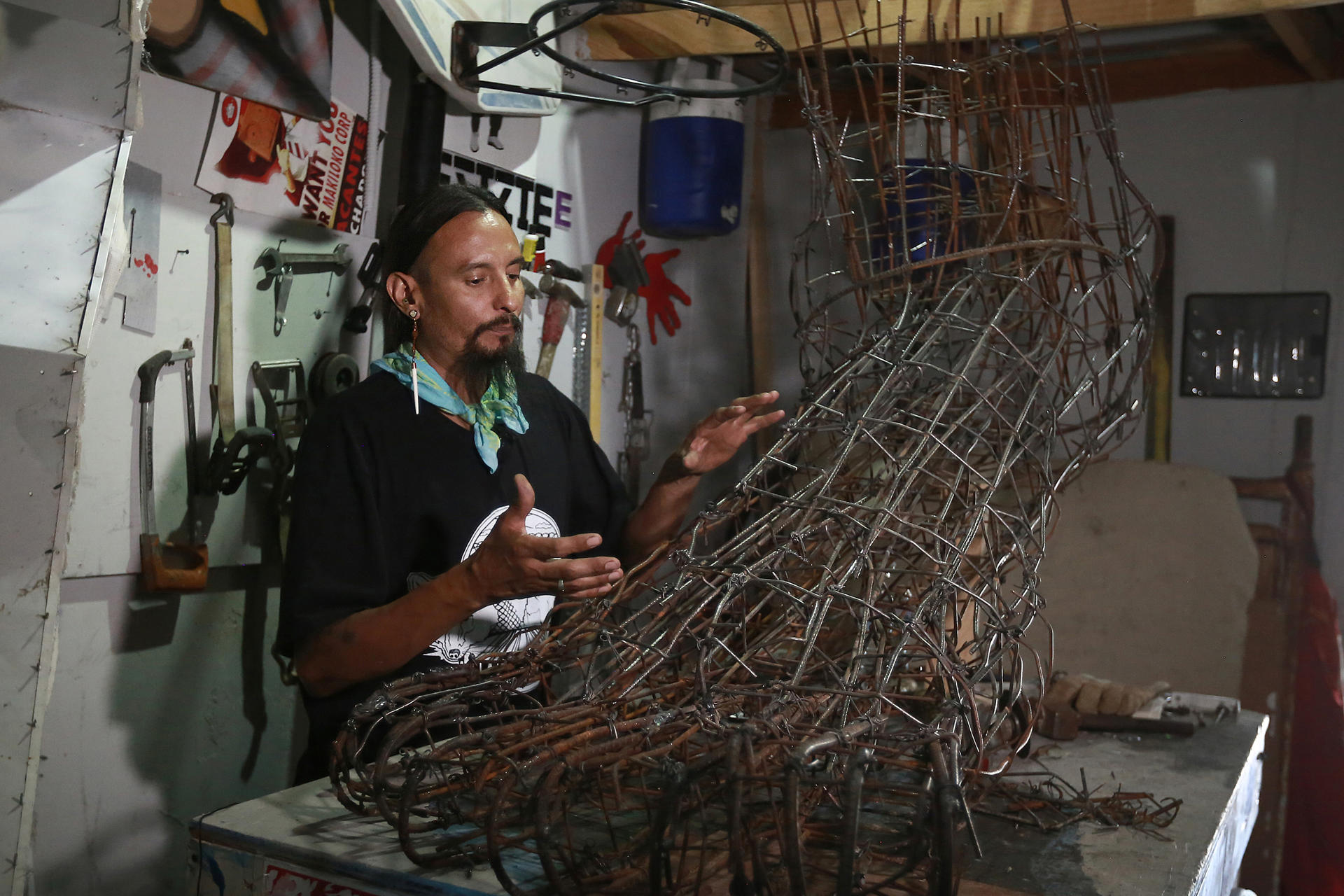 Artist Jorge Alejandro "Yorch" Perez Mendoza at work on his sculpture, Migrant Foot, at his studio in Ciudad Juarez, Mexico, on 4 July 2023.  EFE/Luis Torres