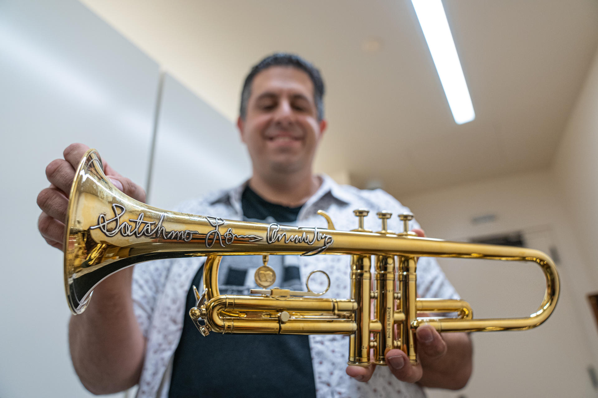 The director of Research Collections at the Louis Armstrong Center in New York, Ricky Riccardi, shows EFE one of the jazz icon's trumpets on 6 July 2023. EFE/Angel Colmenares
