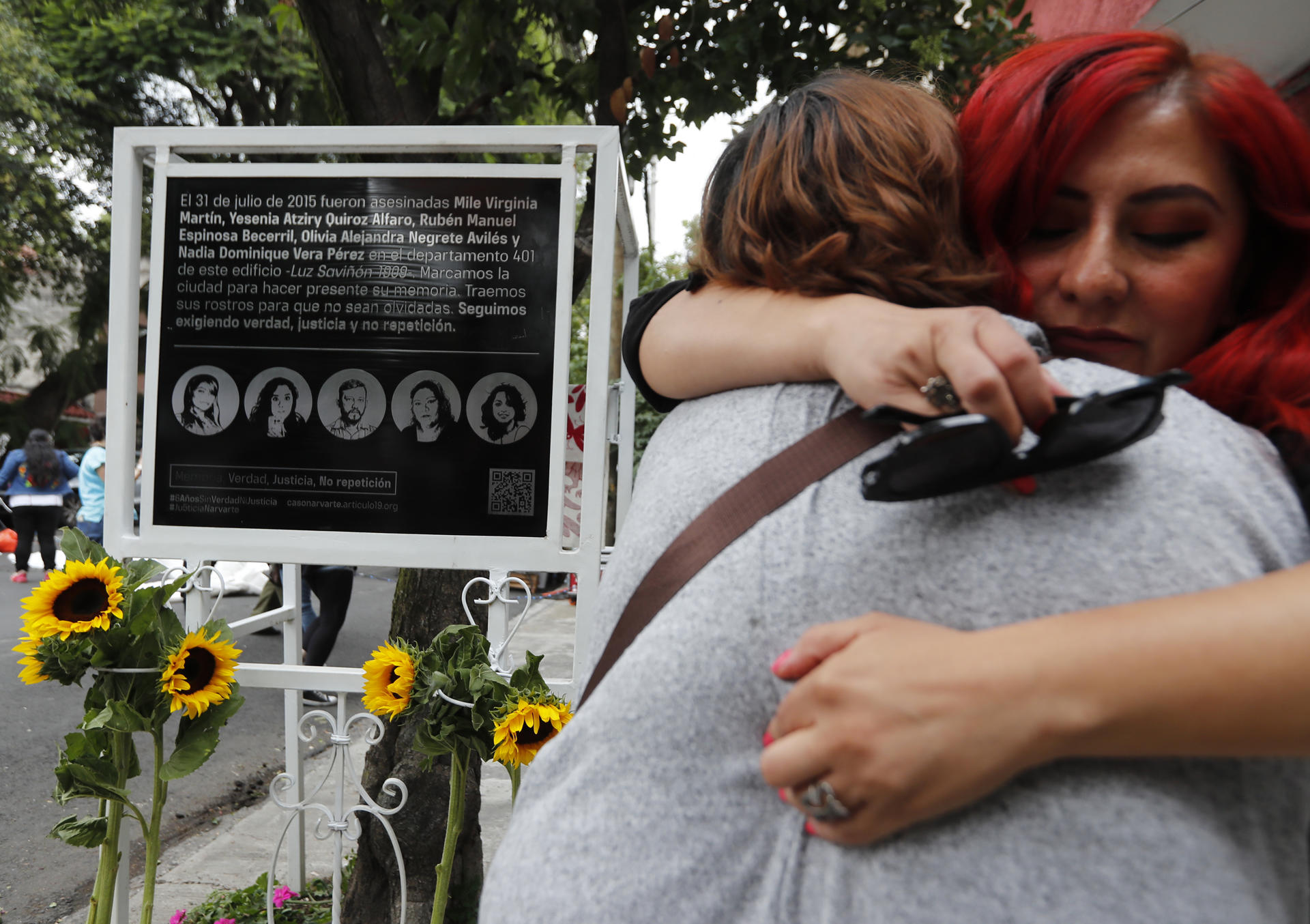 Relatives, friends and activists place flowers on a plaque unveiled during the eighth anniversary of the murder of Mexican photojournalist Rubén Espinosa and the femicide of four women, in Mexico City, Mexico on Oct 30, 2023. EFE/Mario Guzman
