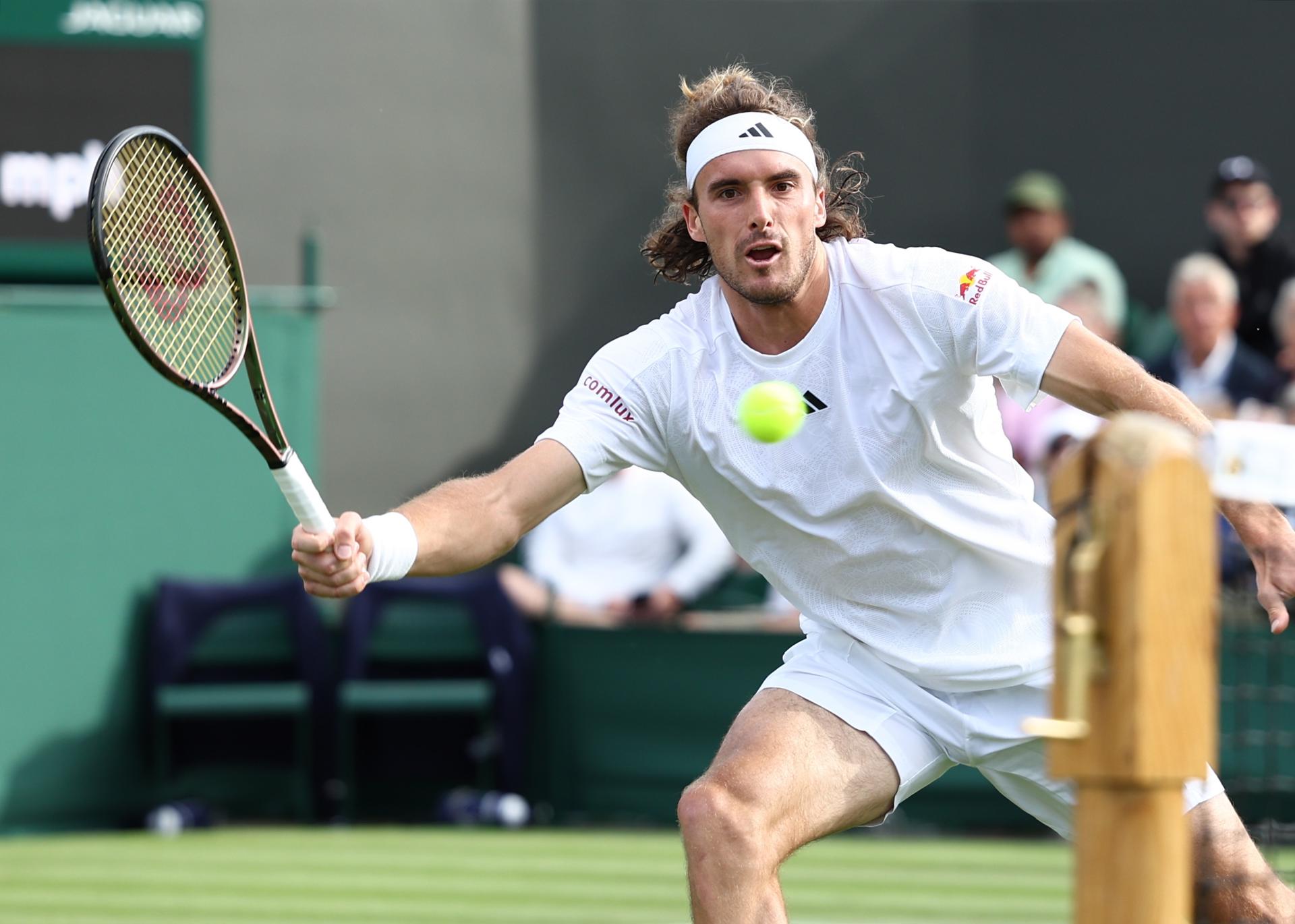 Stefanos Tsitsipas of Greece prepares to hit a forehand volley during his men's singles first-round match against Dominic Thiem of Austria at the Wimbledon Championships, Wimbledon, Britain, on 5 July 2023. Tsitsipas won 3-6, 7-6 (7-1), 6-2, 6-7 (5-7), 7-6 (10-8). EFE/EPA/ADAM VAUGHAN EDITORIAL USE ONLY
