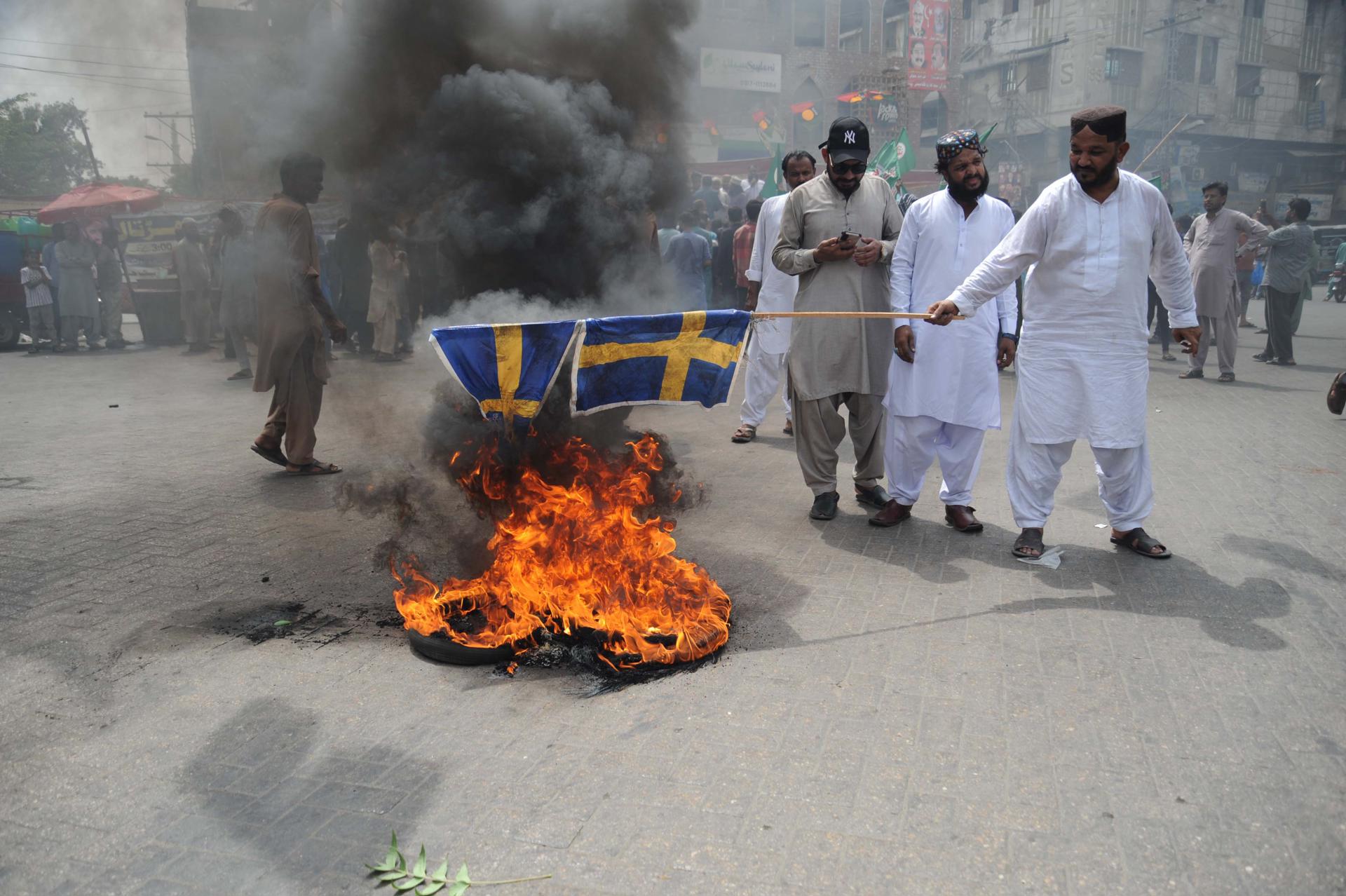 Protesters burn Swedish flags to protest the burning of a copy of the Quran in Sweden, in Hyderabad, Pakistan, 05 July 2023. EFE/EPA/FILE/NADEEM KHAWAR