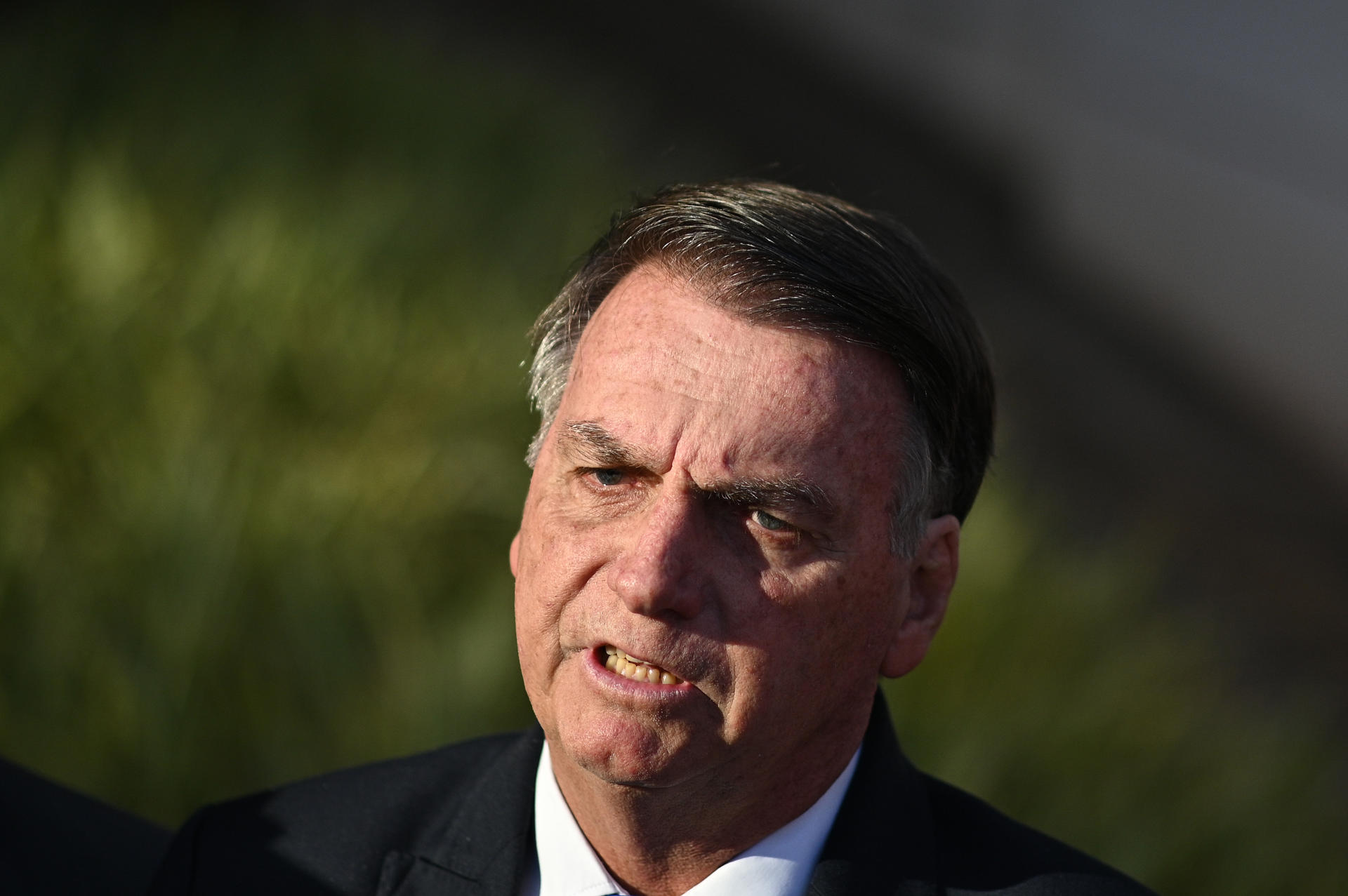 Former President Jair Bolsonaro talks to reporters outside Brazilian Federal Palace headquarters in Brasilia on 12 July 2023. EFE/Andre Borges