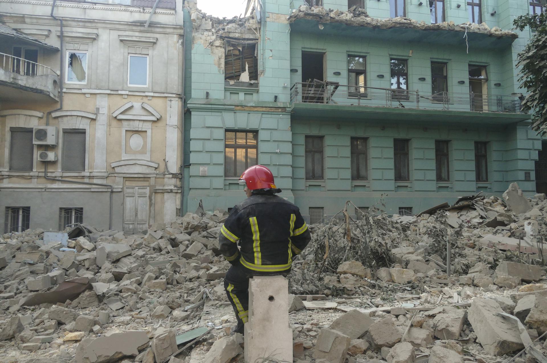 A rescuer worker takes a rest near a shelling-damaged residential building in Odesa, southern Ukraine, 23 July 2023. EFE-EPA/IGOR TKACHENKO