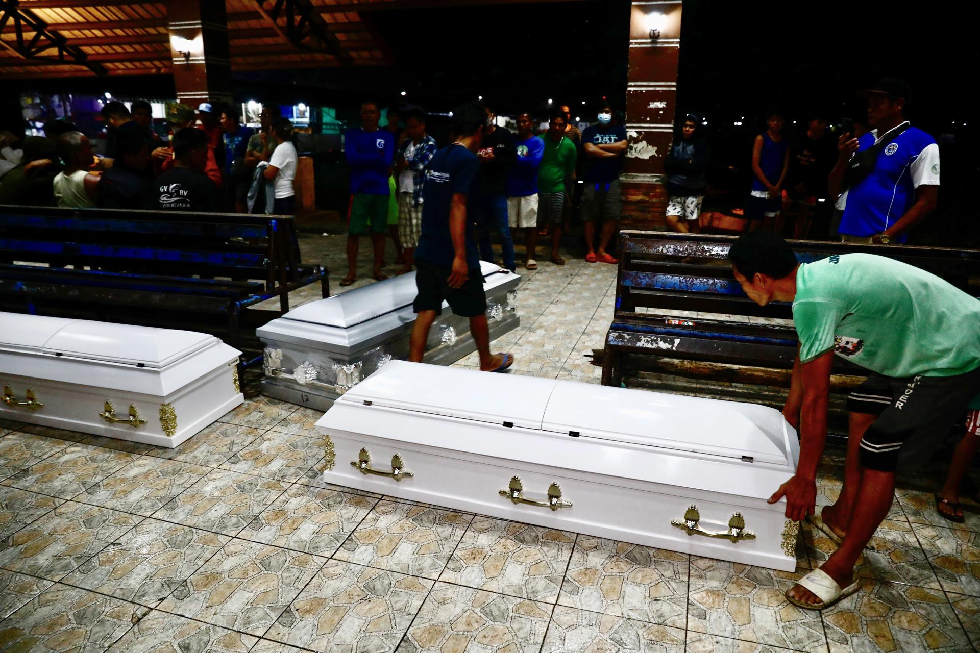 Coffins of victims lay on the ground after a passenger boat capsized, at the Binangonan port, Rizal province, Philippines, 27 July 2023. EFE-EPA/FRANCIS R. MALASIG