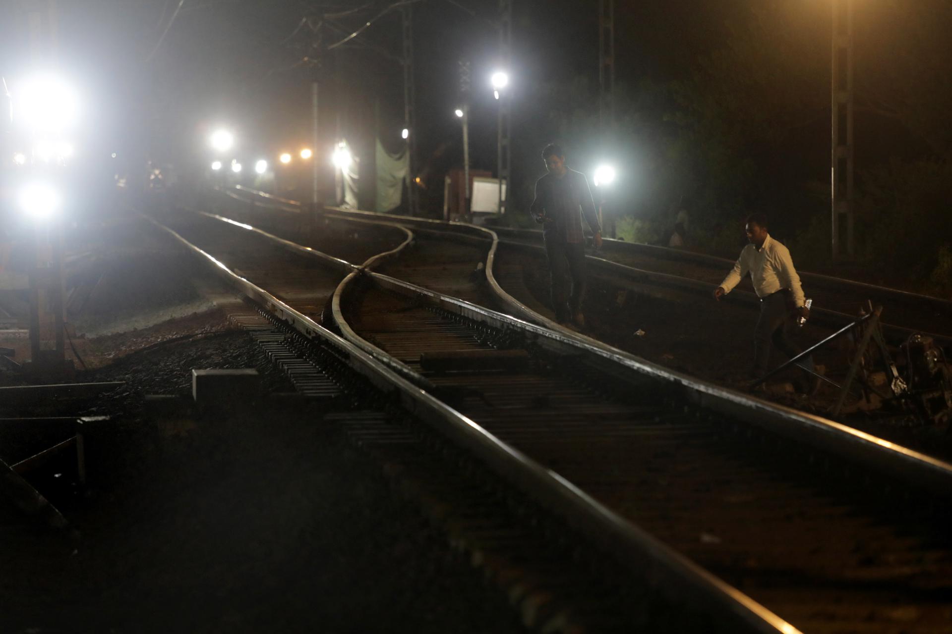 An Indian Railway officer (R) crosses the newly installed railway track during a trial run at Odisha's Balasore, India, 05 June 2023. EFE-EPA FILE/PIYAL ADHIKARY