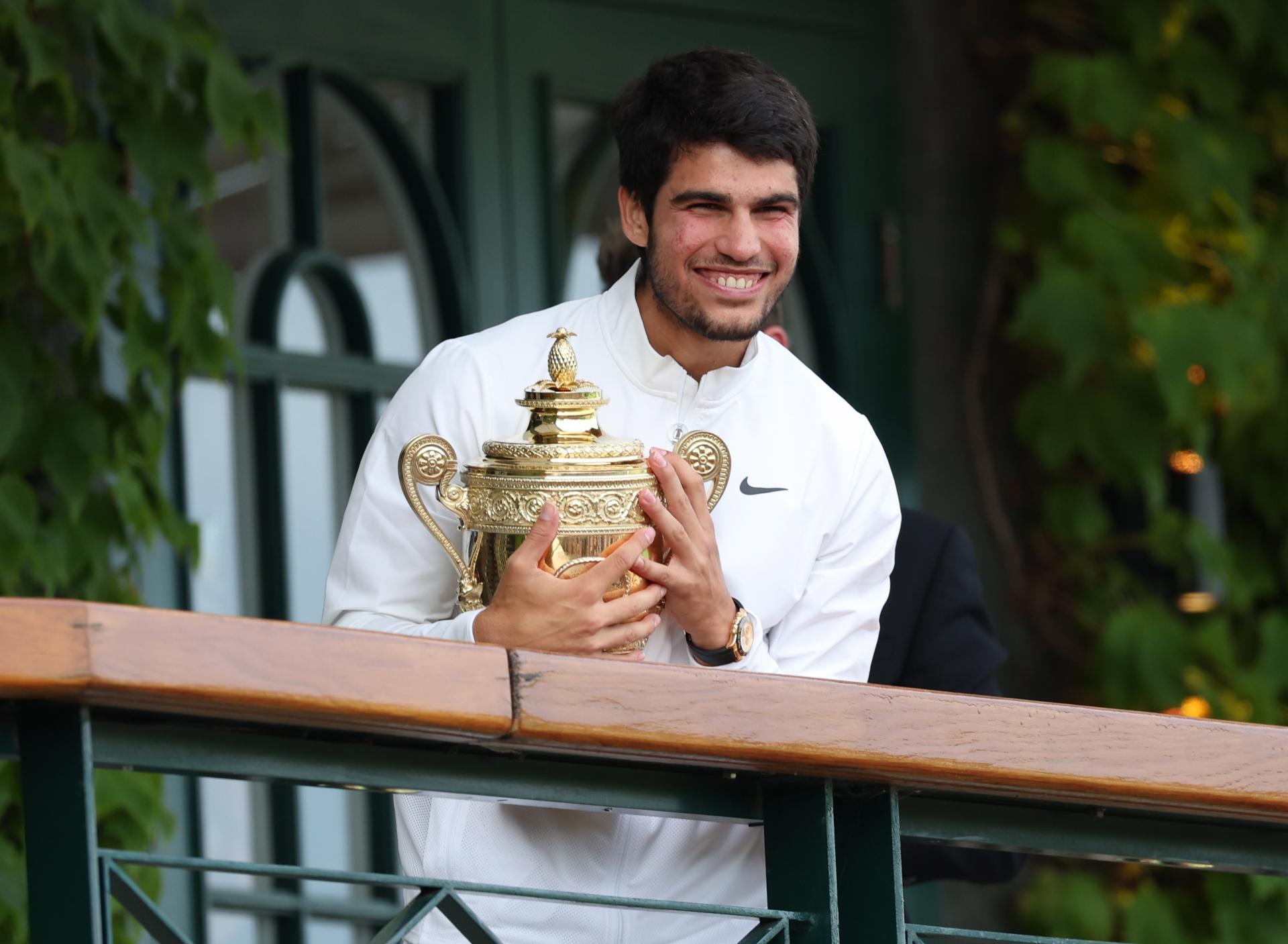 Spanish world No. 1 Carlos Alcaraz holds the Wimbledon trophy he captured by defeating Serbian great Novak Djokovic in the final on 16 July 2023. EFE/EPA/ISABEL INFANTES