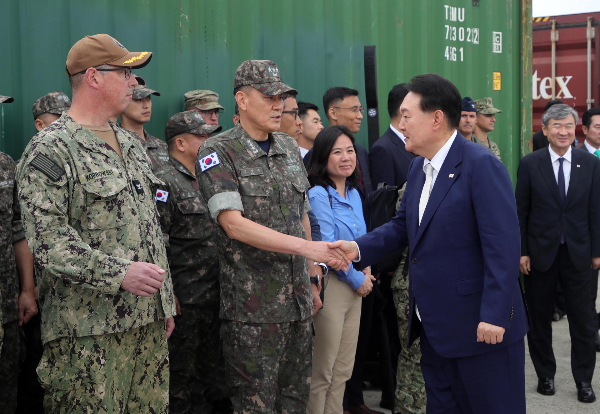 South Korean President Yoon Suk Yeol (R) shakes hands with Naval Operations Commander V. Adm. Kim Myung-soo (C) during a visit to the command in Busan, southeast of Seoul, South Korea, 19 July 2023. EFE/EPA/KOREA POOL SOUTH KOREA OUT
