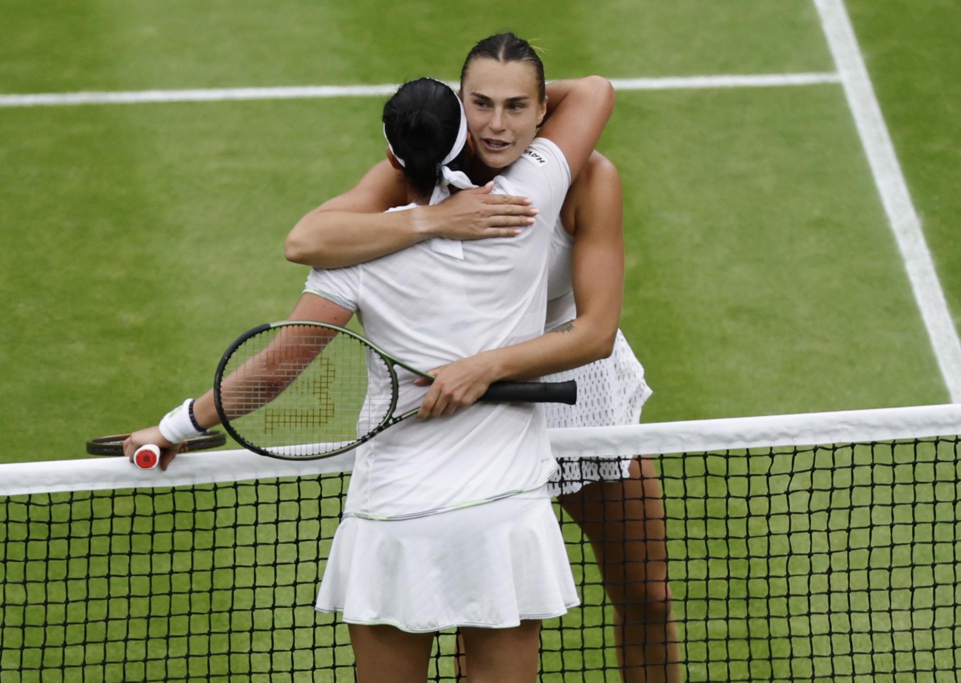 Belarusian Aryna Sabalenka (facing the camera) congratulates Tunisia's Ons Jabeur at the net after losing their Wimbledon women's singles semifinal 6-7 (5-7), 6-4, 6-3 on 13 July 2023 in London, United Kingdom. EFE/EPA/ISABEL INFANTES
