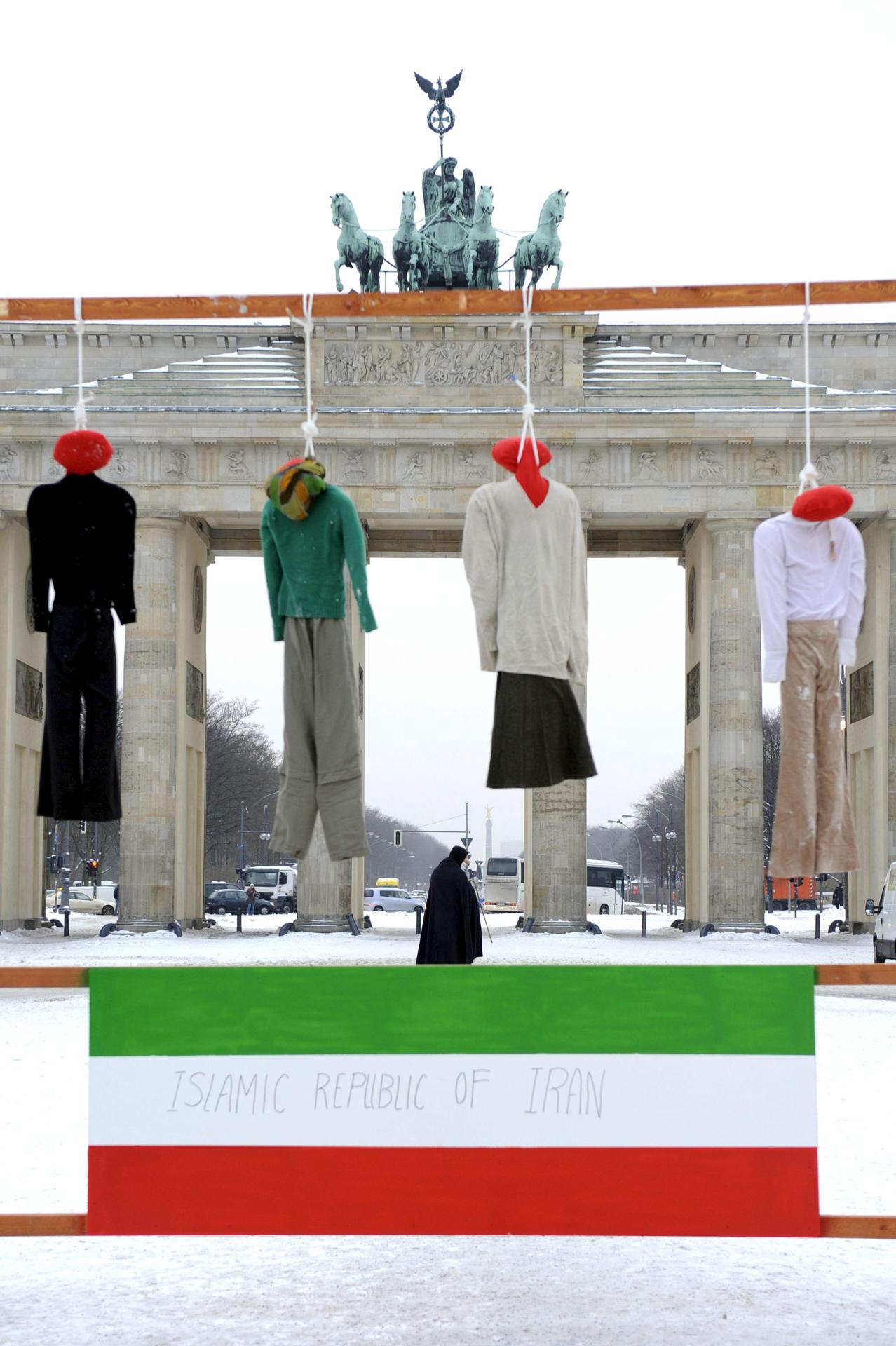 A file picture of protest with the symbolic execution of four dolls on top of an Iranian flag outside the Brandenburg Gate in Berlin, Germany. EFE/FILE/Robert Schlesinger