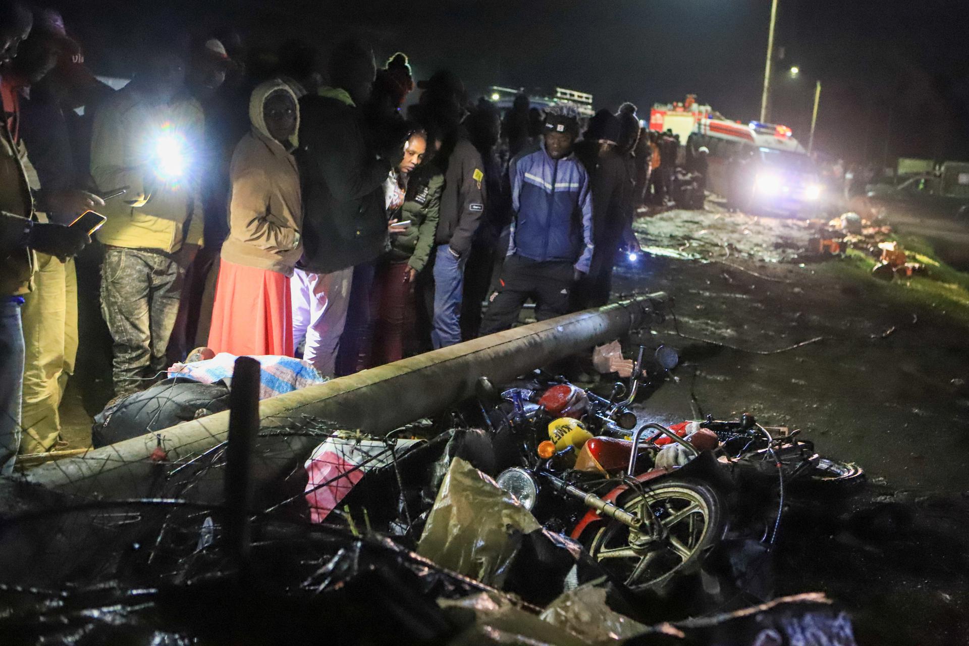 People mill around and search through the aftermath of a traffic accident in Londiani Junction area along the Kericho-Nakuru highway in Kericho County, Kenya's Rift Valley region, Kenya, 01 July 2023. EFE/EPA/STR
