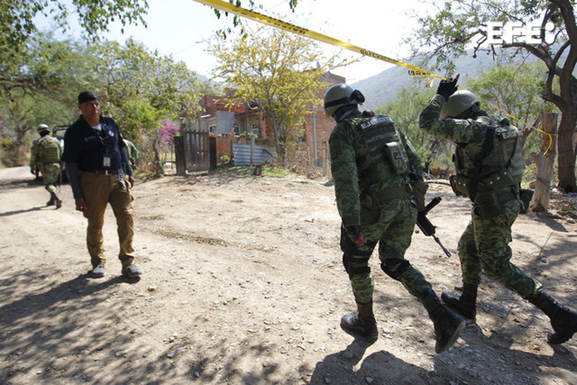 Soldiers help secure the crime scene in Tlajomulco, Mexico, on 12 July 2023, following an attack with explosives that left six police dead and 12 wounded. EFE/Francisco Guasco