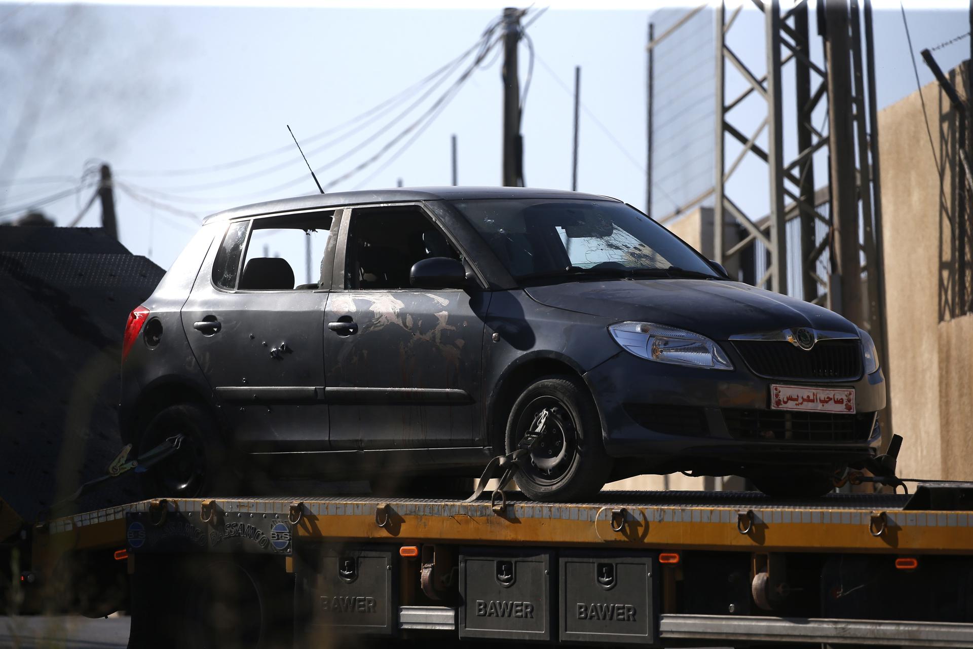 A trailer tows a car from the area where three Palestinians were shot near the West Bank city of Nablus, 25 July 2023. EFE-EPA/ALAA BADARNEH
