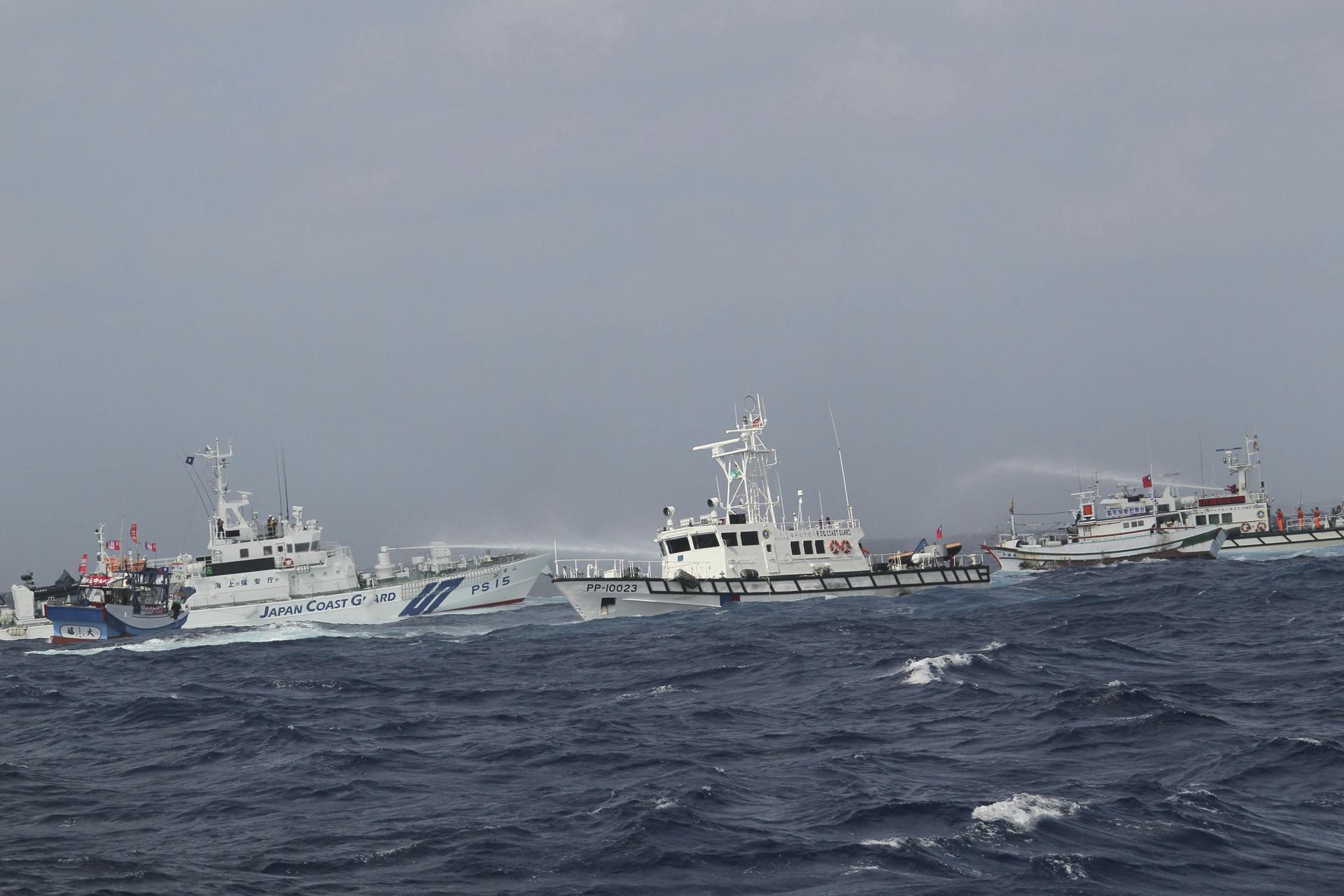 A picture made available on 10 April 2013 shows a Japan Coast Guard ship (C-L) sprays water on a Taiwan Coast guard ship (R) on 25 September 2012, as 58 Taiwan fishing boats and 12 Taiwan coast guard shps sailed to Diaoyu Islands to assert Taiwan's claim to Diaoyu Islands and fishing rights in Diaoyu Island waters. EPA/STR