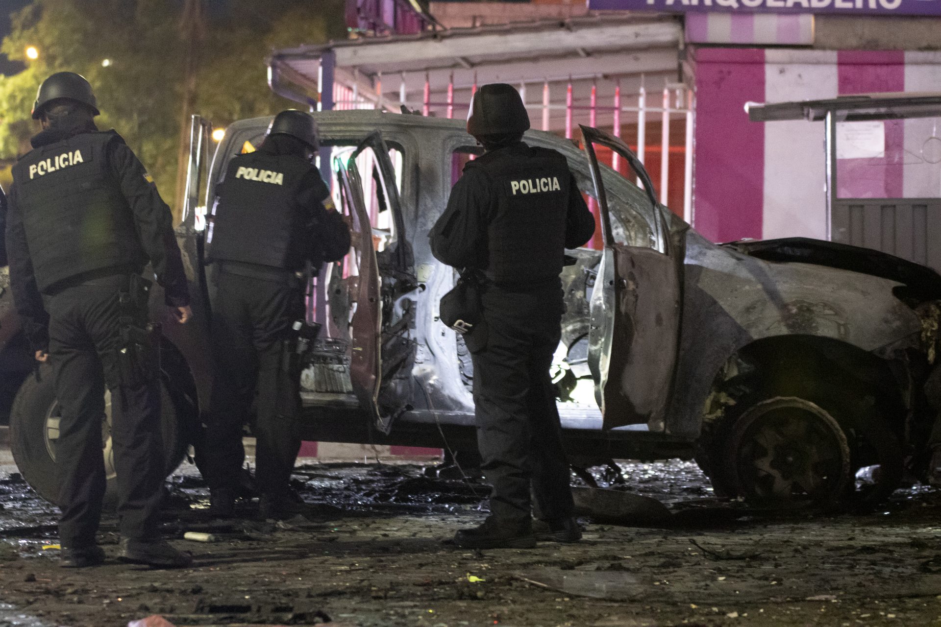 Policías investigan los restos de un carro bomba que explotó en la madrugada en los exteriores del edificio del Servicio Nacional de Atención Integral a Personas Privadas de Libertad (SNAI), en Quito (Ecuador). EFE/STR