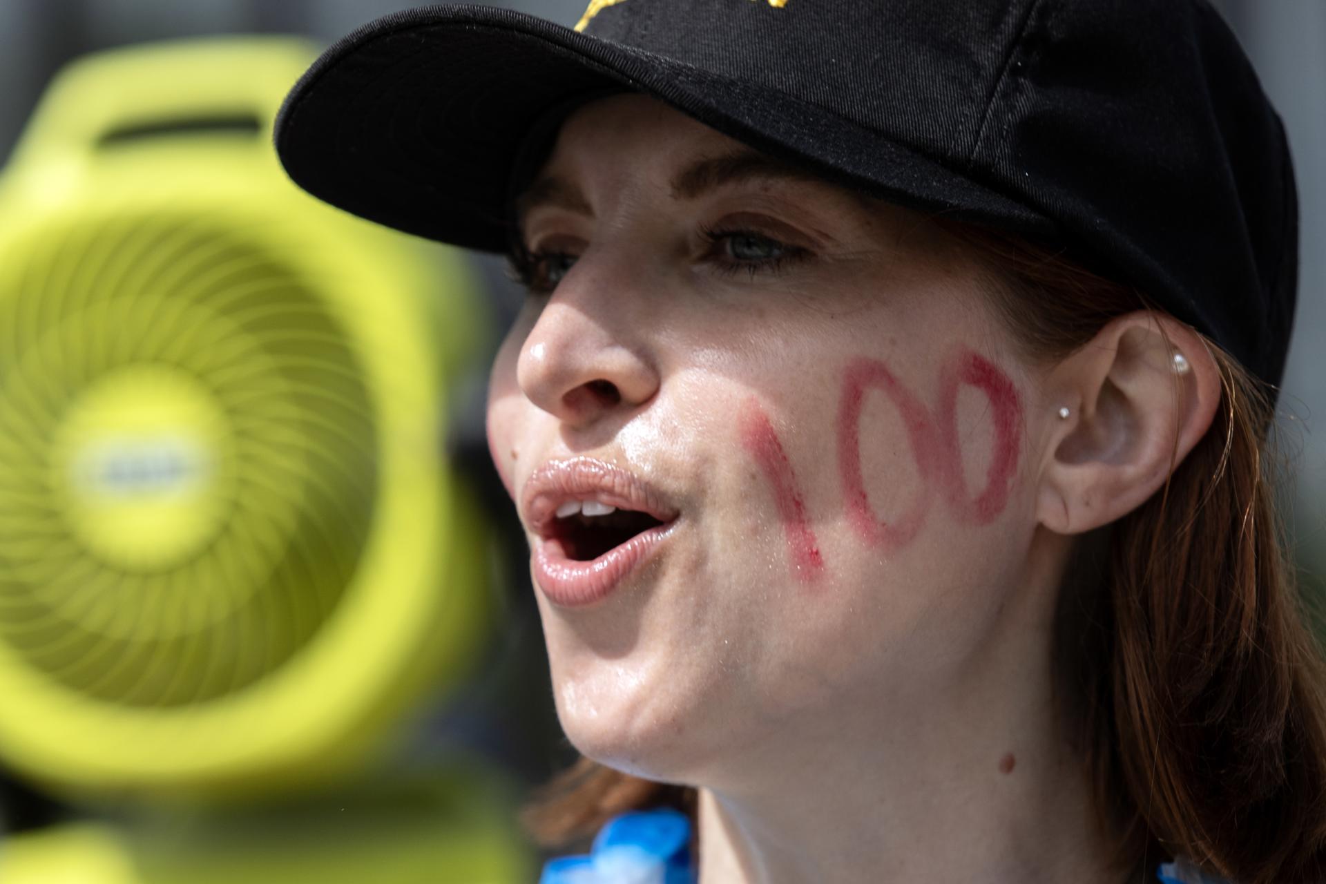 A demonstrator displays on her cheek the number '100' as members of the Writers Guild of America (WGA) protest in front of the Netflix headquarter in Los Angeles, California, USA, 09 August 2023. EFE-EPA/ETIENNE LAURENT/FILE
