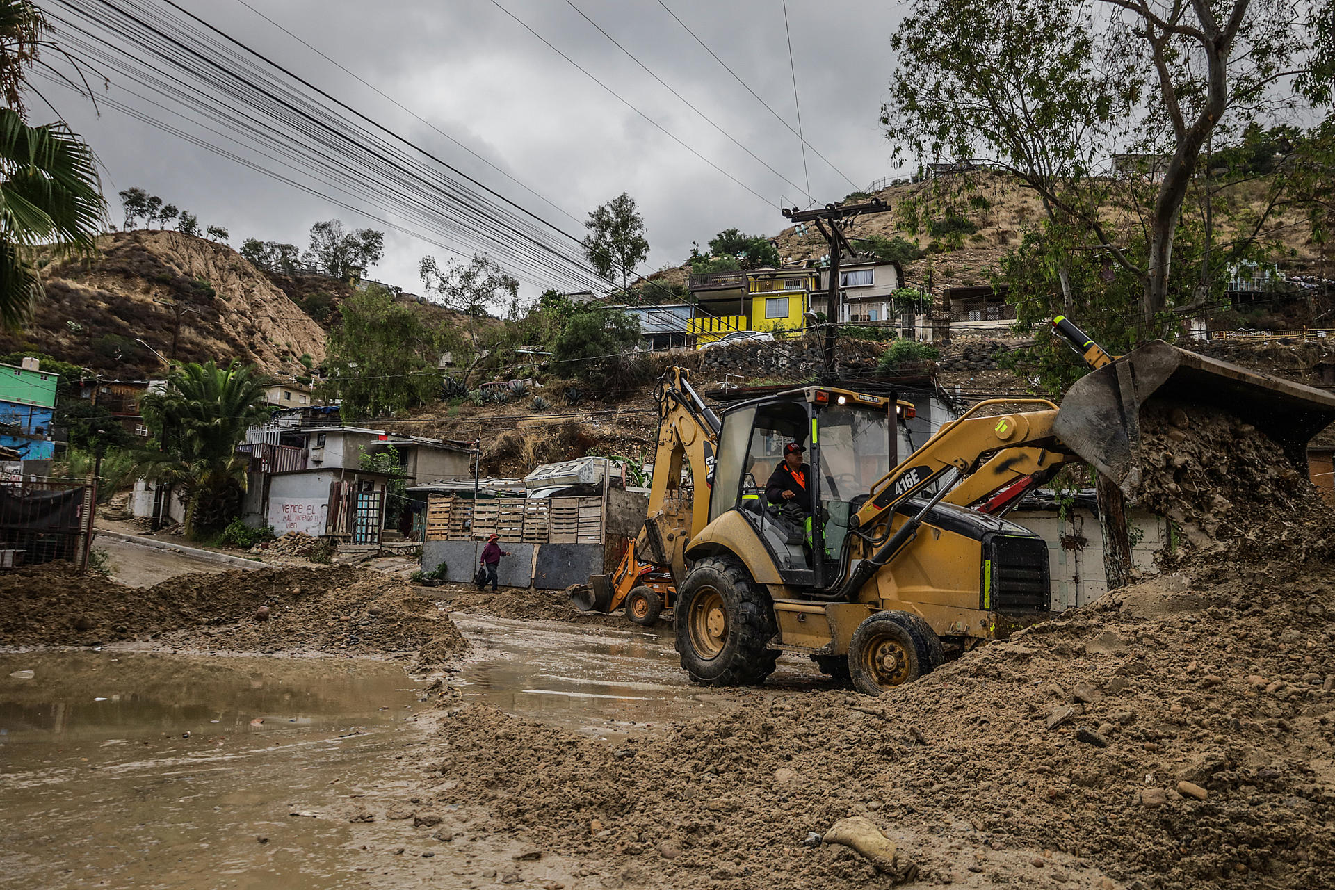 A man works cleaning a road after a landslide due to heavy rains by the pass of Hilary tropical storm, in Tijuana, Mexico, 21 August 2023. EFE-EPA/Joebeth Terriquez