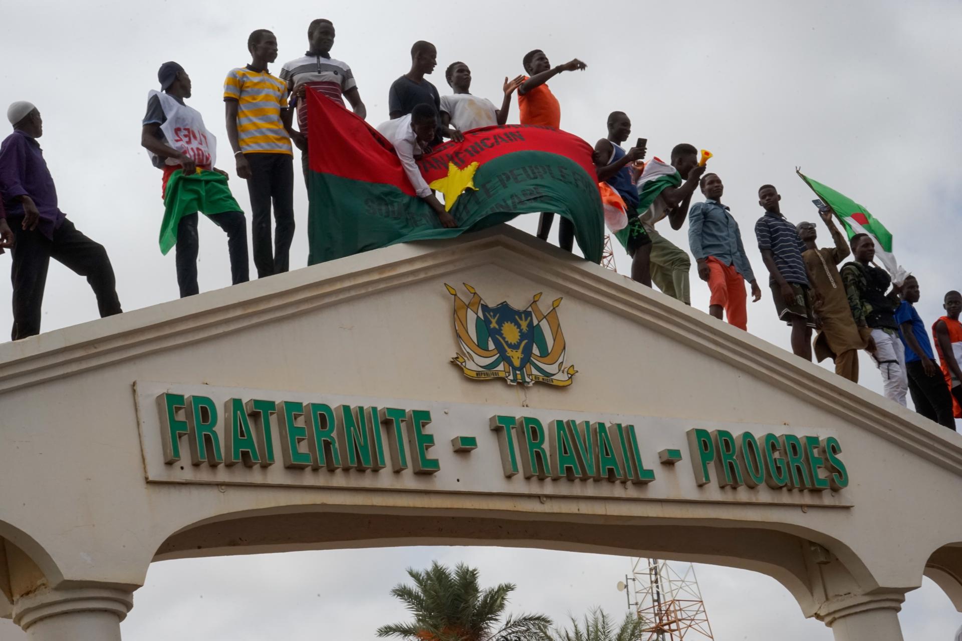 Protesters stand on top of the entrance to the National Assembly during a rally in Niamey, Niger, 03 August 2023. EFE/EPA/ISSIFOU DJIBO
