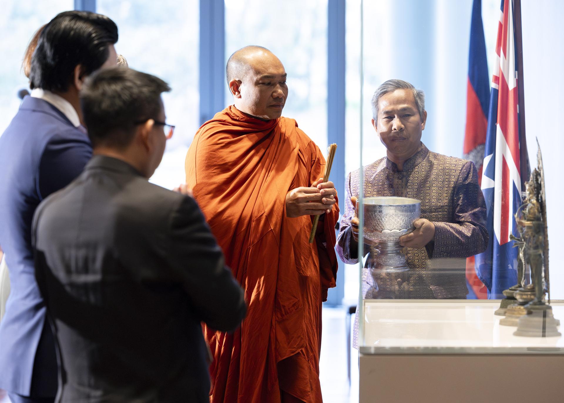 An undated handout photo shows a ceremonial Buddhist blessing by the Venerable Phin Sokol, Abbot of Khemararangsi Buddhist Temple, and Temple Committee Chief Mr Kong Sambok, pictured with Bodhisattva Avalokiteshvara with attendants, at the National Gallery of Australia, Kamberri/Canberra, 2023. EFE/HANDOUT/Karlee Holland/National Gallery of Australia