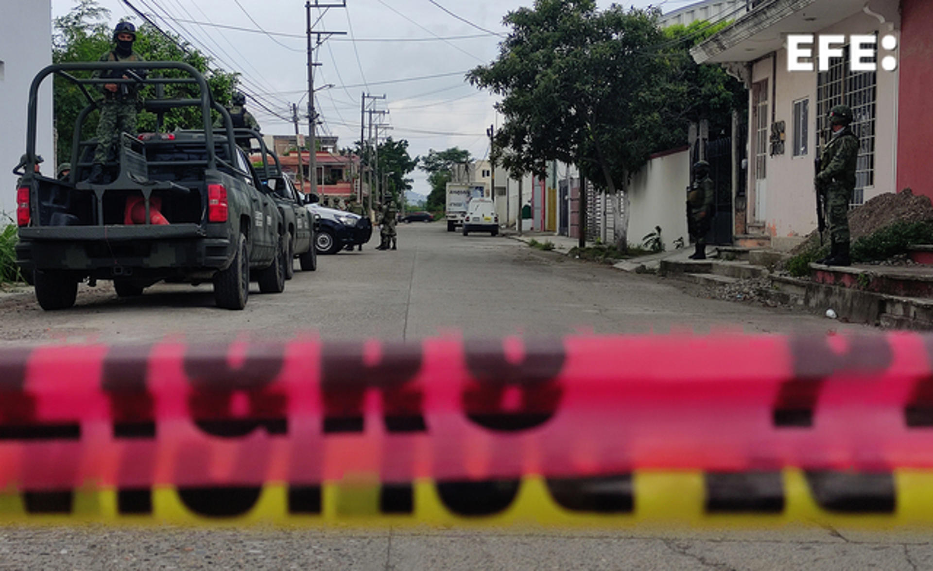 Army troops secure the scene in Poza Rica, Mexico, on 14 August 2023, the day after dozens of dismembered bodies were found in residences used as safe houses by criminal organizations. EFE/Edgar Escamilla