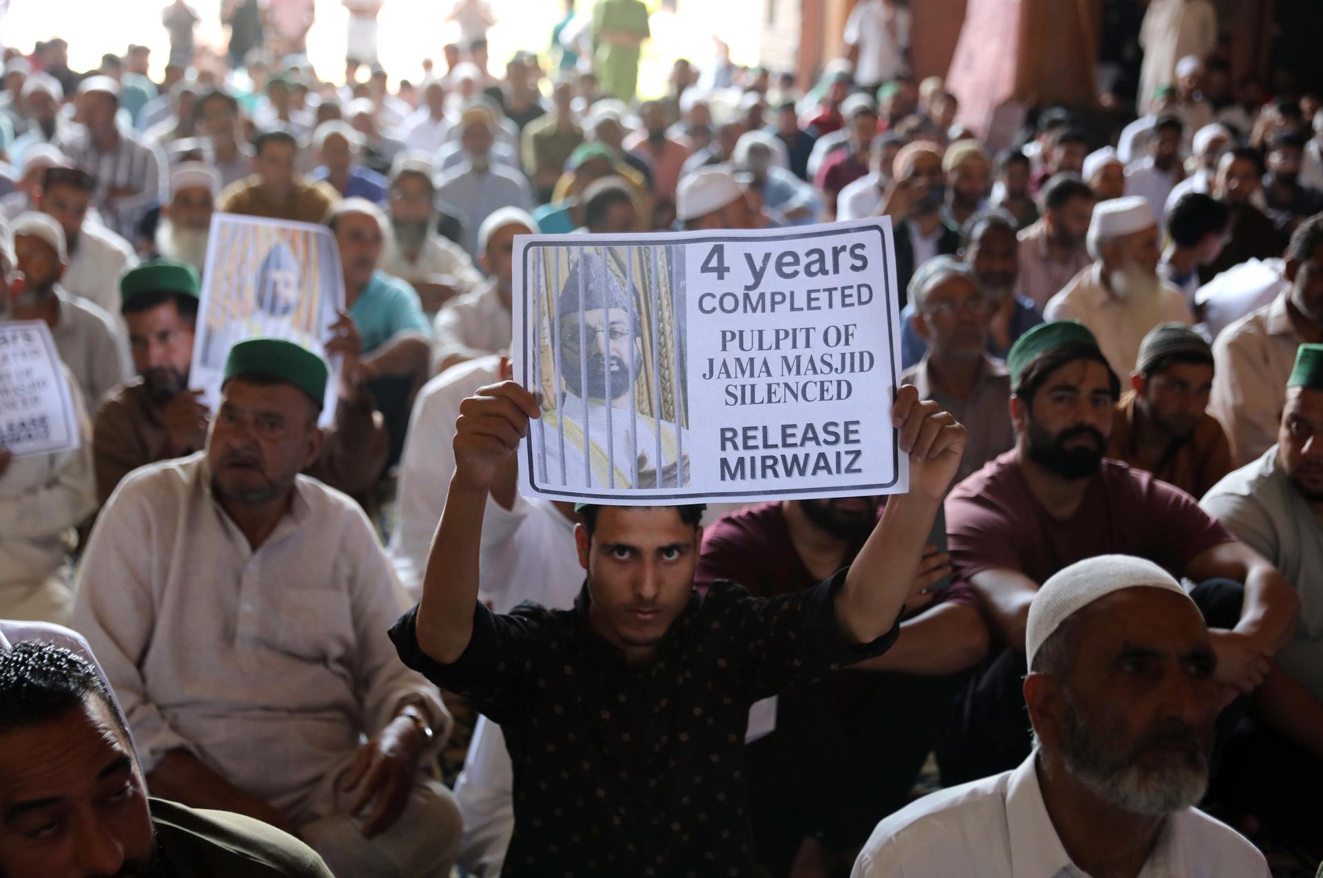 Kashmiri men hold placards with photograph of separatist leader Mirwaiz Umar Farooq, as a mark of protest demanding his release inside Jamia Masjid in Srinagar, the summer capital of Indian Kashmir, 04 August 2023. EFE-EPA/FAROOQ KHAN