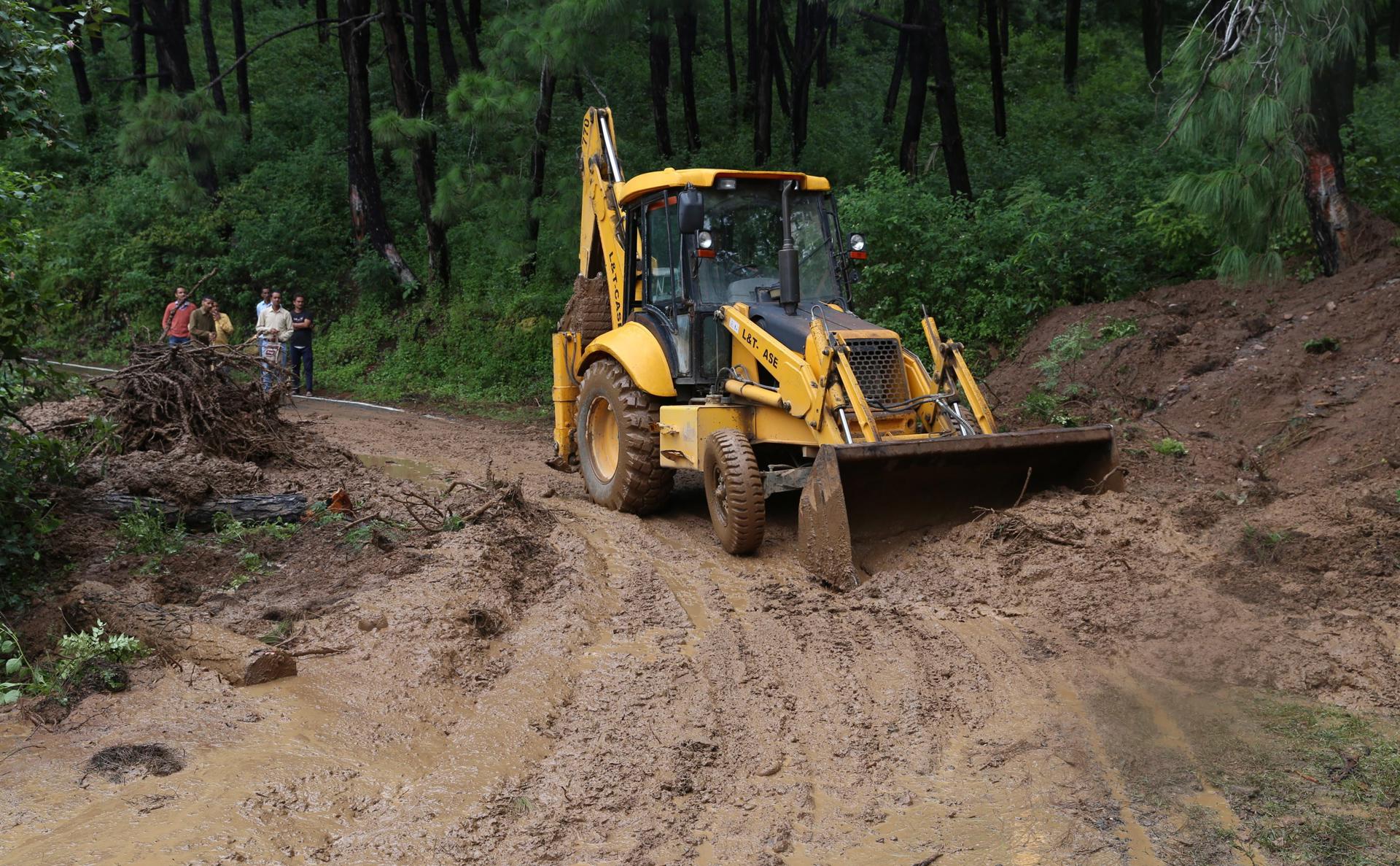 A file picture shows workers using a bulldozer to clear up the debris at the site of a landslide in Nagrota Bagwan in Himachal Pradesh, India. EPA/EFE/FILE/SANJAY BAID