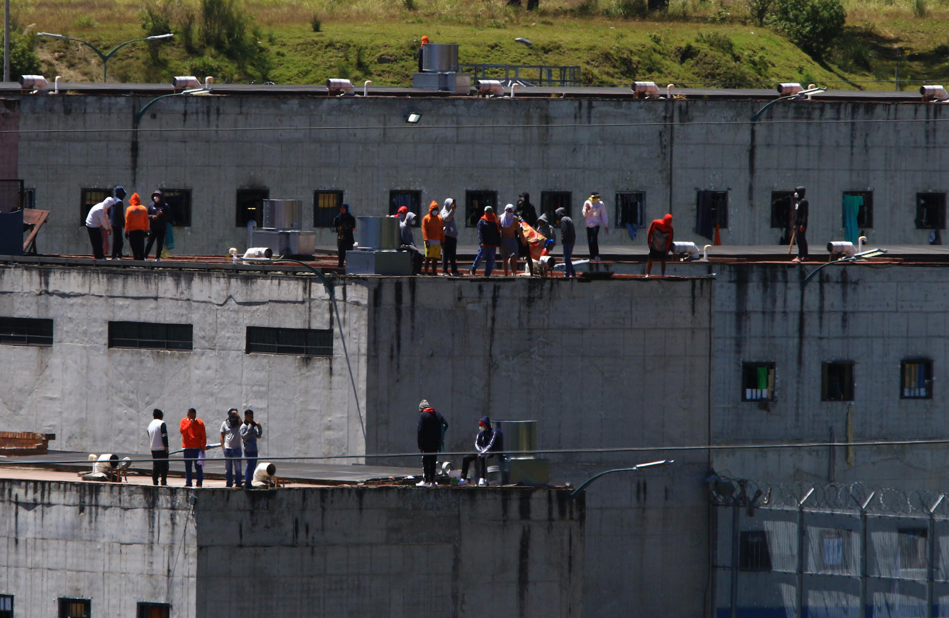 Prisoners take the roofs of "El Turi" prison, in the city of Cuenca, Ecuador, on 30 August 2023. EFE-EPA/Robert Puglla
