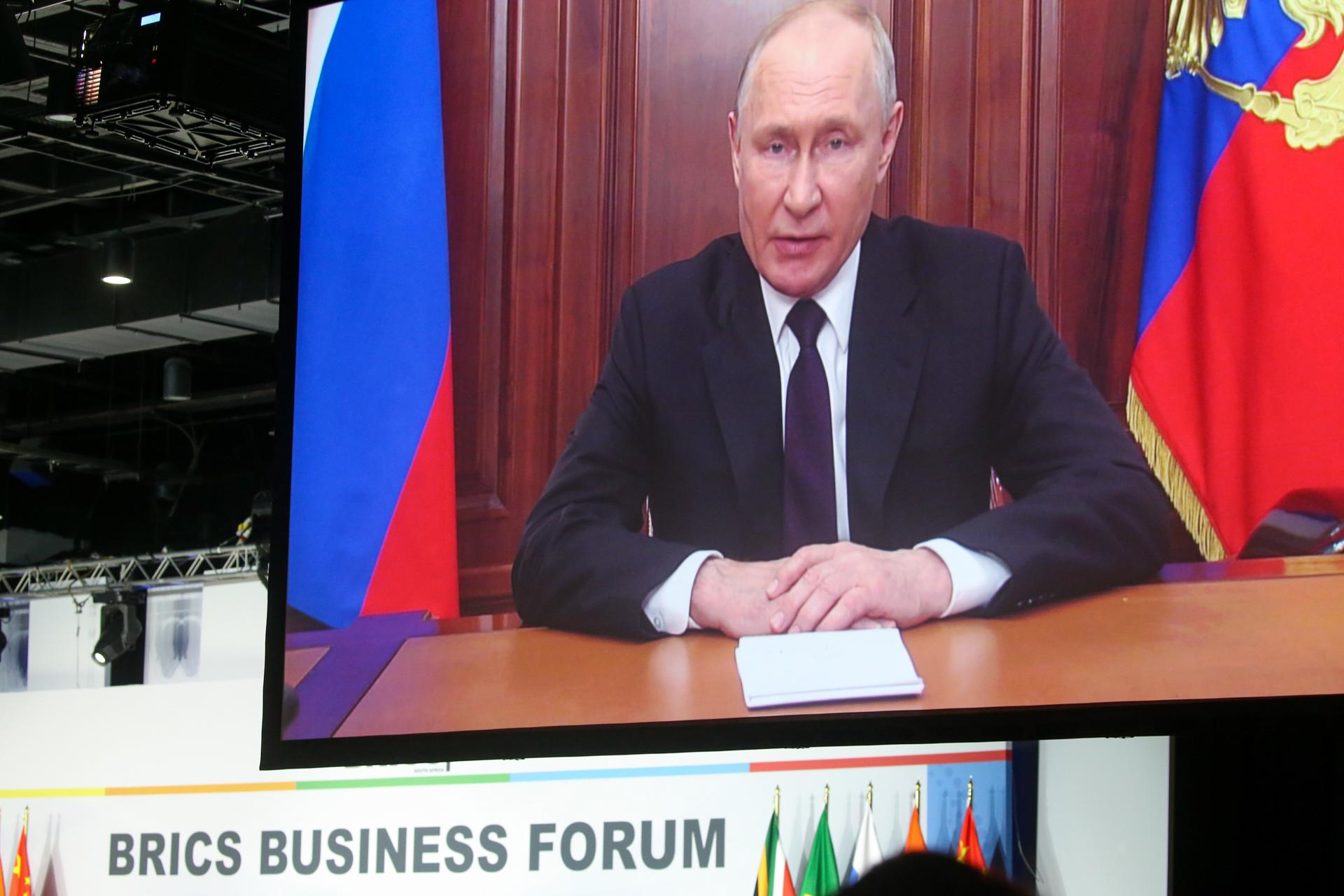 President of Russia Vladimir Putin appears on a monitor as he delivers a recorded speech off location during the 15th BRICS Summit in Johannesburg, South Africa, 22 August 2023. EFE/EPA/KIM LUDBROOK
