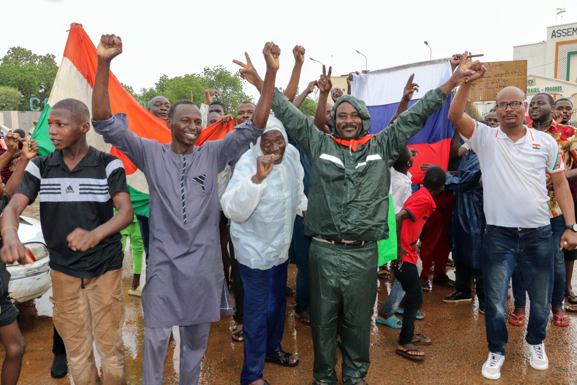 Supporters of putschist soldiers hold Niger's flags as they celebrate outside the National Assembly building in Niamey, Niger, 27 July 2023. EFE-EPA/FILE/STR