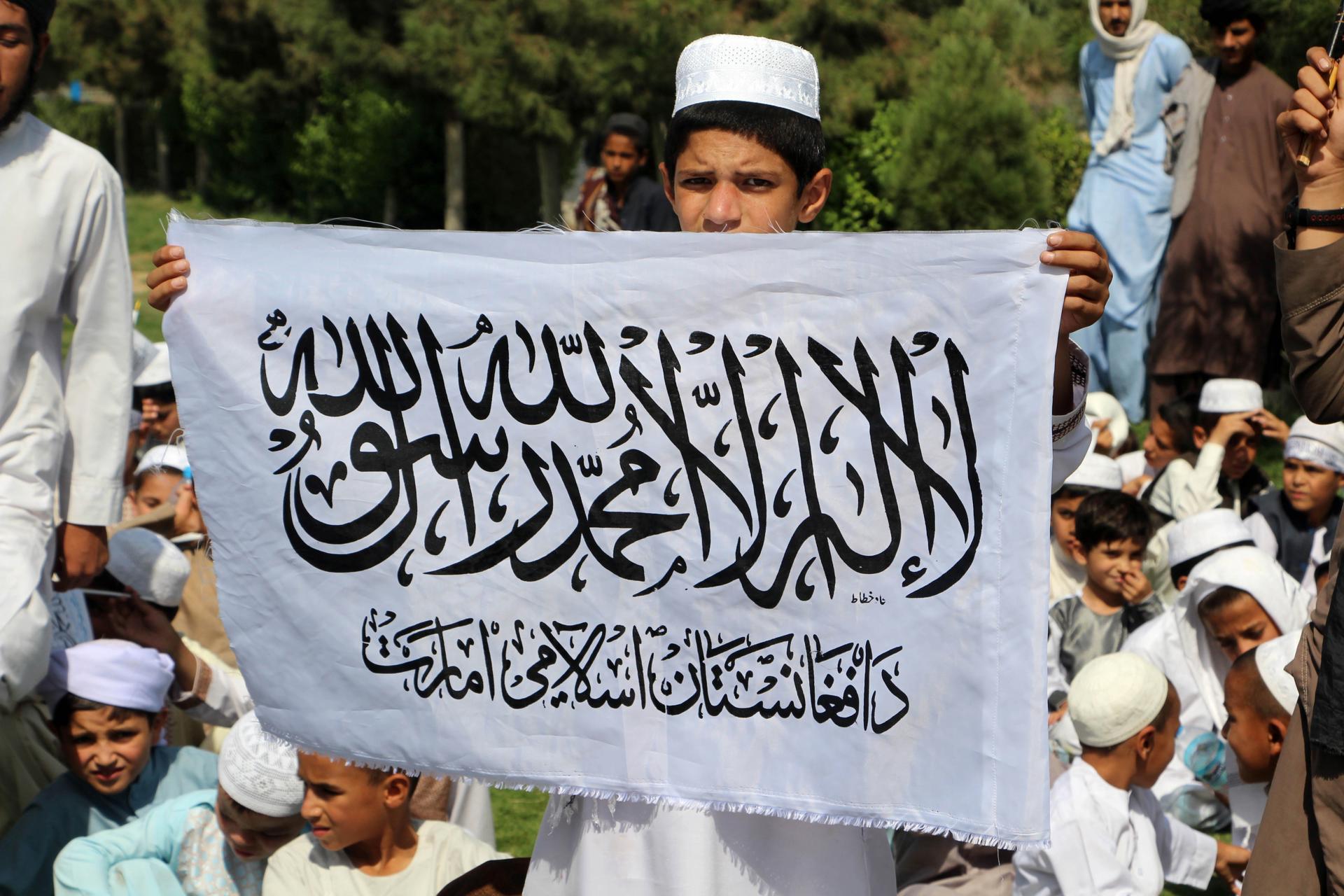 Afghan boys hold Taliban government flag reading in Arabic 'There is no God but Allah, Muhammad is the messenger of Allah' as they to mark the 2nd anniversary of the US withdrawal, in Kandahar, Afghanistan, 31 August 2023. EFE-EPA/STRINGER
