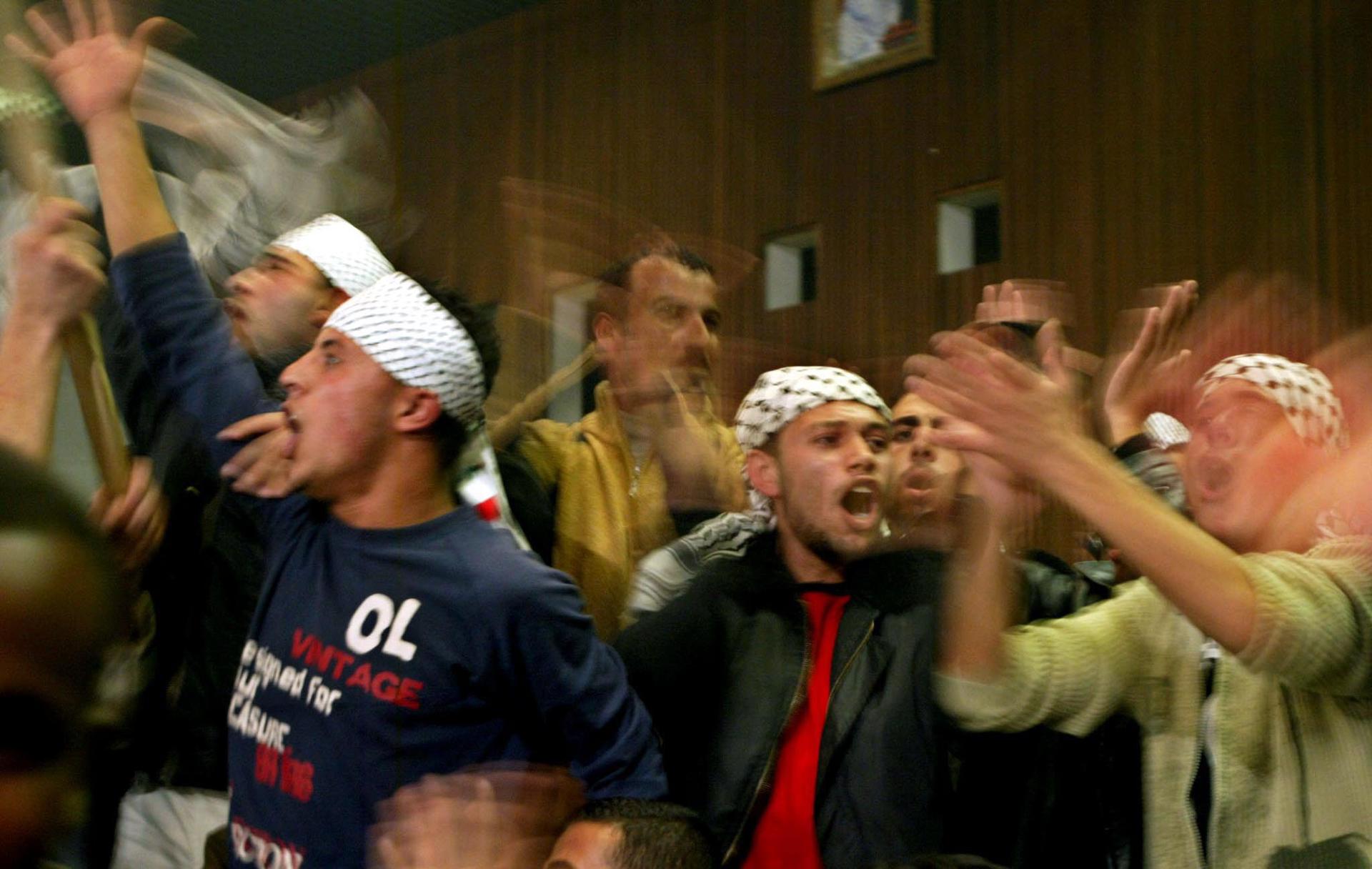 epa000334606 Palestinian supporters of Palestinian Liberation Organisation chairman Mahmoud Abbas shouting during a rally in Gaza City, 23 December 2004. Over 140,000 Palestinians were slated to cast ballots Thursday in municipal elections in 25 West Bank towns andvillages, in what Palestine Liberation Organization chief MahmudAbbas said was "part of a comprehensive national plan to renew the legitimacy" of the Palestine Authority. EPA/Ali Ali