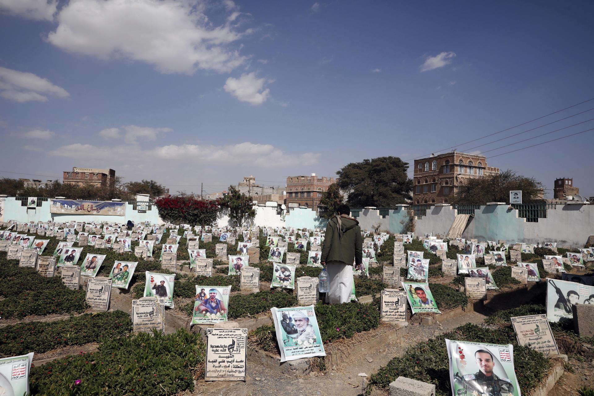 A Yemeni walks amongst portraits on the graves of those who were killed in the prolonged conflict, at a cemetery in Sana'a, Yemen, 12 December 2022. EFE-EPA/YAHYA ARHAB