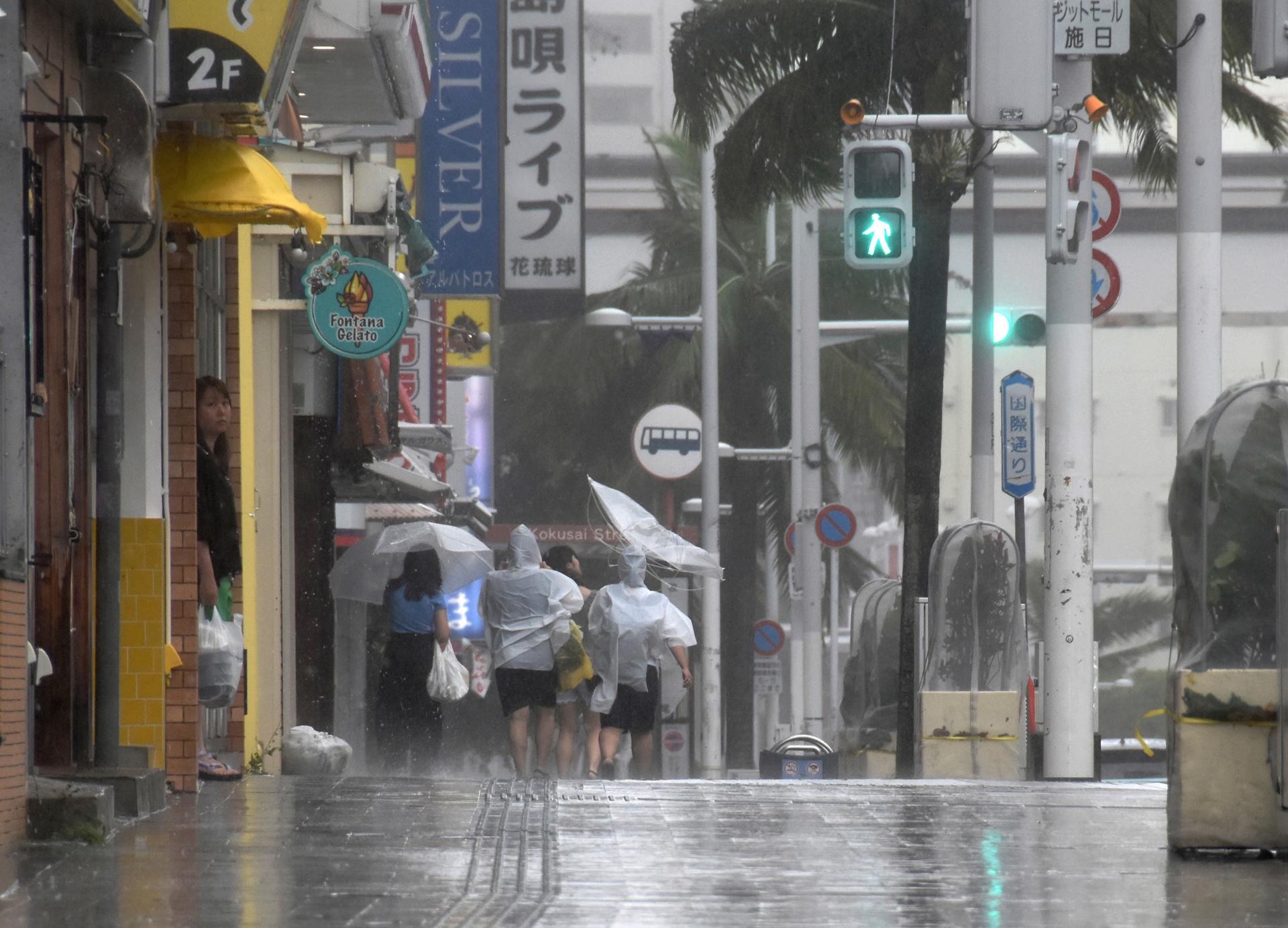 People walk along Kokusai-dori under strong wind and rain by Typhoon Khanun in Naha, Okinawa Prefecture, Japan, 02 August 2023. EFE-EPA/JIJI PRESS JAPAN OUT EDITORIAL USE ONLY