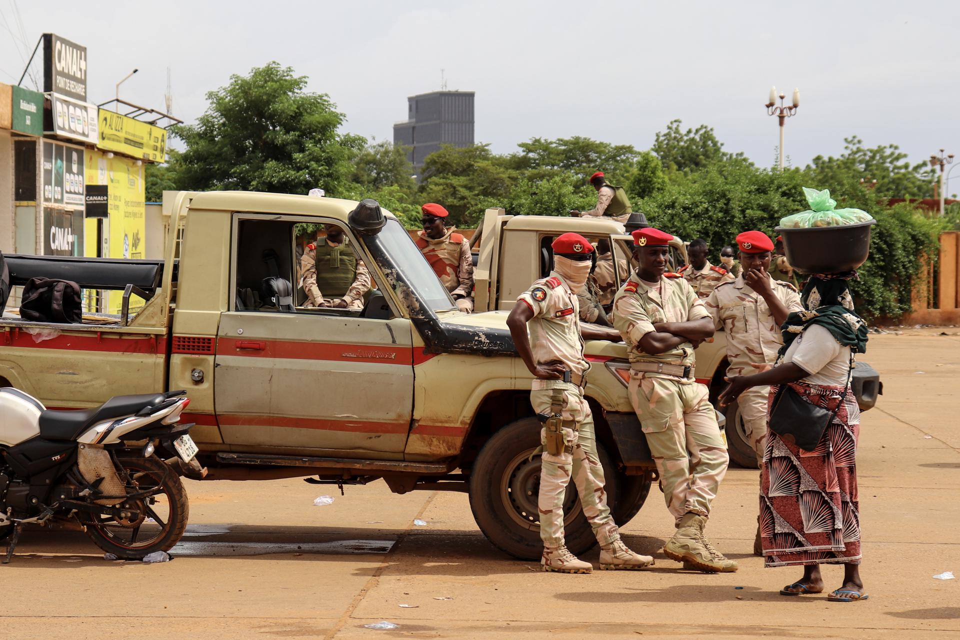 Soldiers speak with a woman outside a stadium, where junta supporters hold their rally, in Niamey, Niger, 26 August 2023. EFE-EPA/ISSIFOU DJIBO