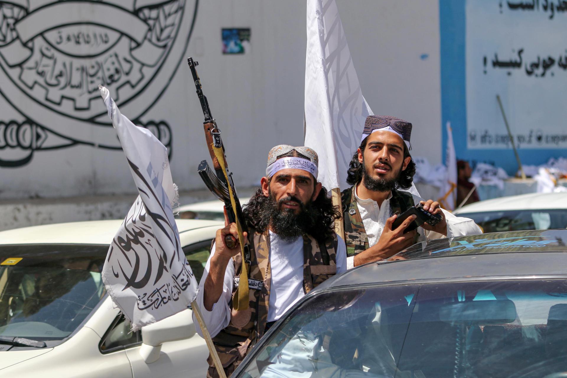 Afghans hold Islamic Emirate of Afghanistan'Äôs flags as they mark the second anniversary of the Taliban taking over the Afghan government, in Kabul, Afghanistan, 15 August 2023. EFE-EPA/SAMIULLAH POPAL
