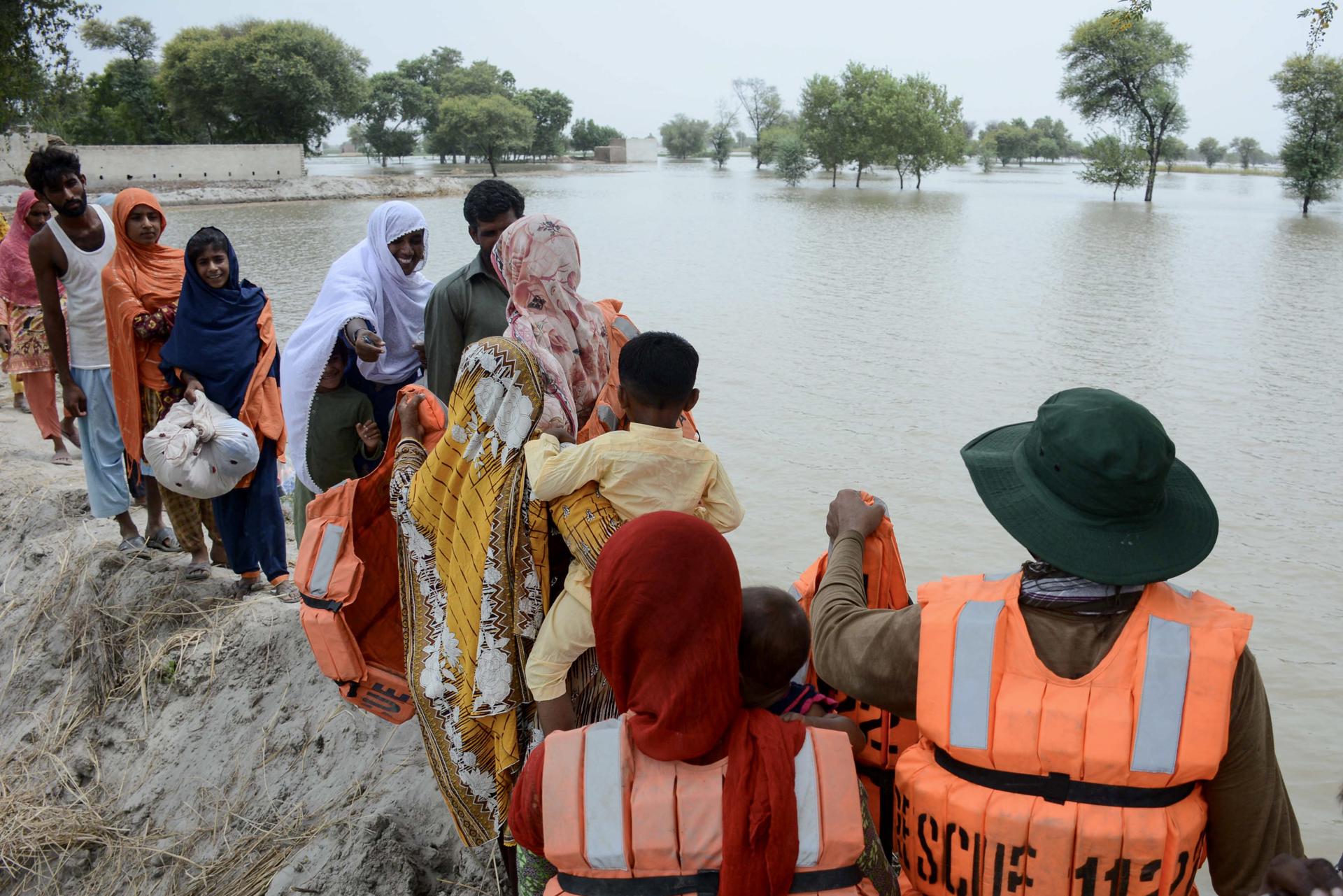 Rescue officials help evacuate victims from a flooded area in Noora Nath, Pakpattan district, Punjab province, Pakistan, 23 August 2023. EFE-EPA FILE/FAISAL KAREEM