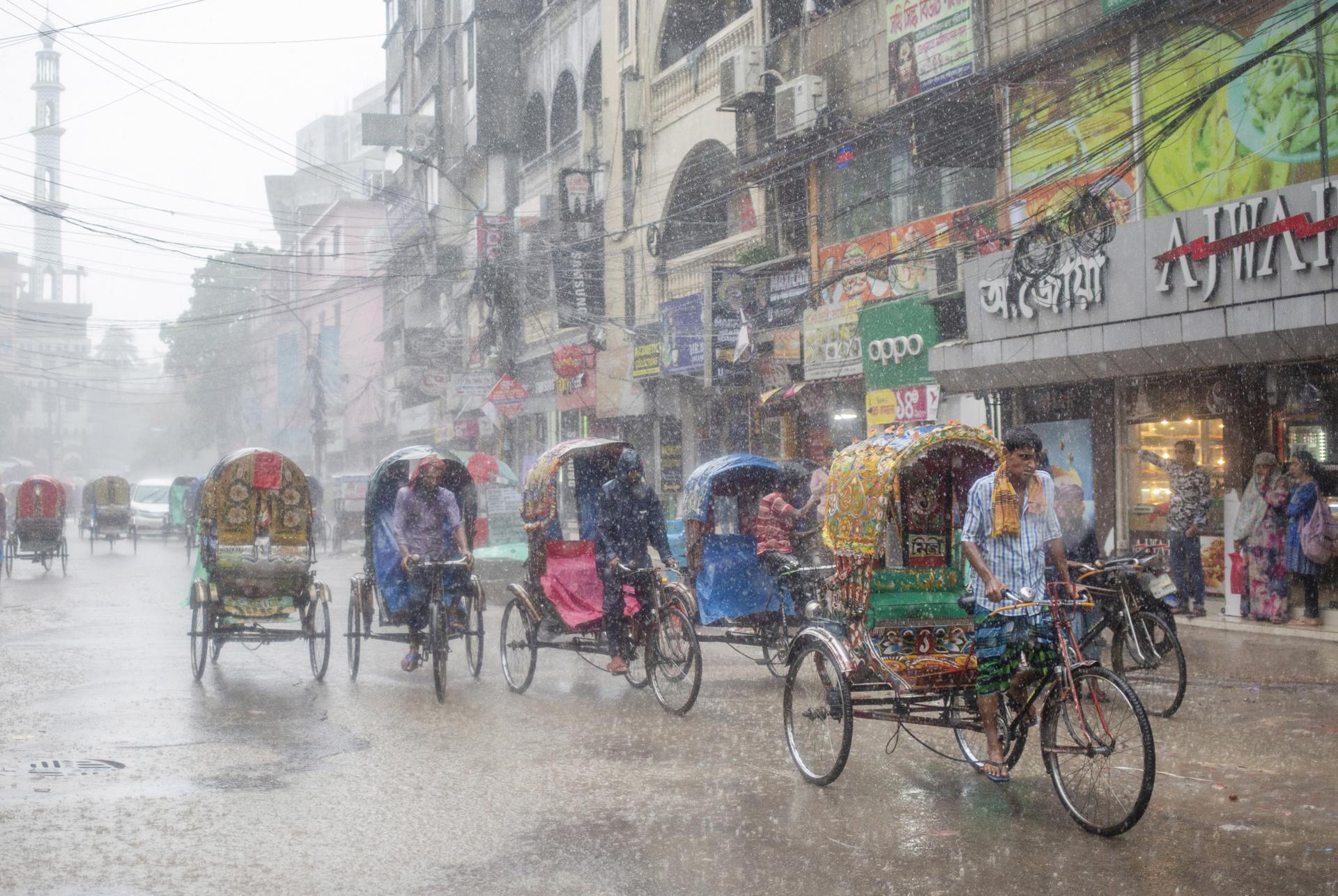 A file picture shows rickshaw pullers riding their rickshaws during rain in Dhaka, Bangladesh. EFE/EPA/FILE/MONIRUL ALAM